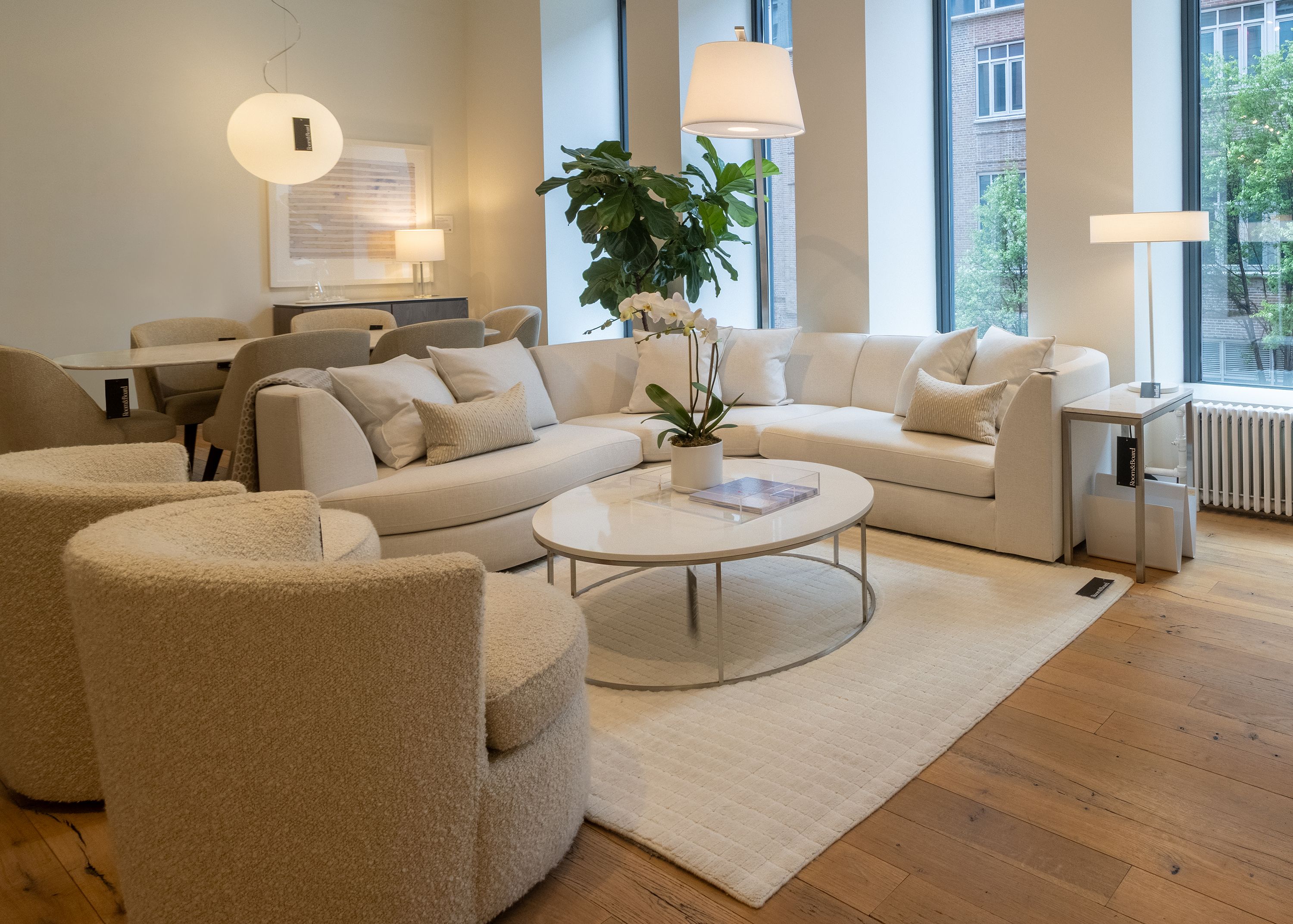 Store image with an Astaire sectional sofa in Sumner Ivory and 2 Otis swivel chairs in Dornick Ivory.