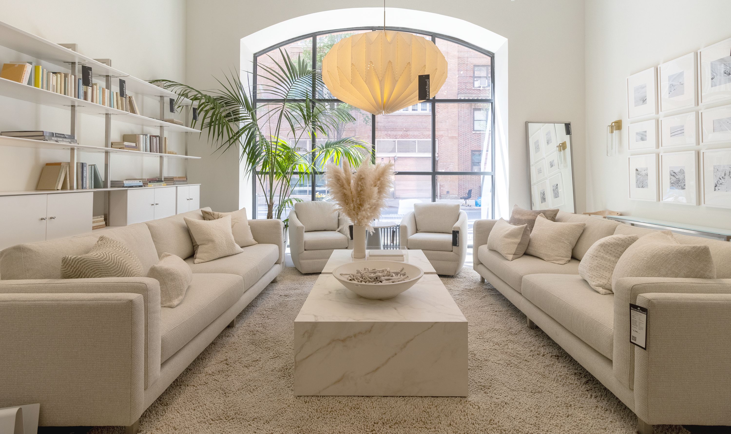 Store image with 2 Cade sofas and 2 Ford swivel chairs all in Orla Ivory and 2 Leona coffee tables.