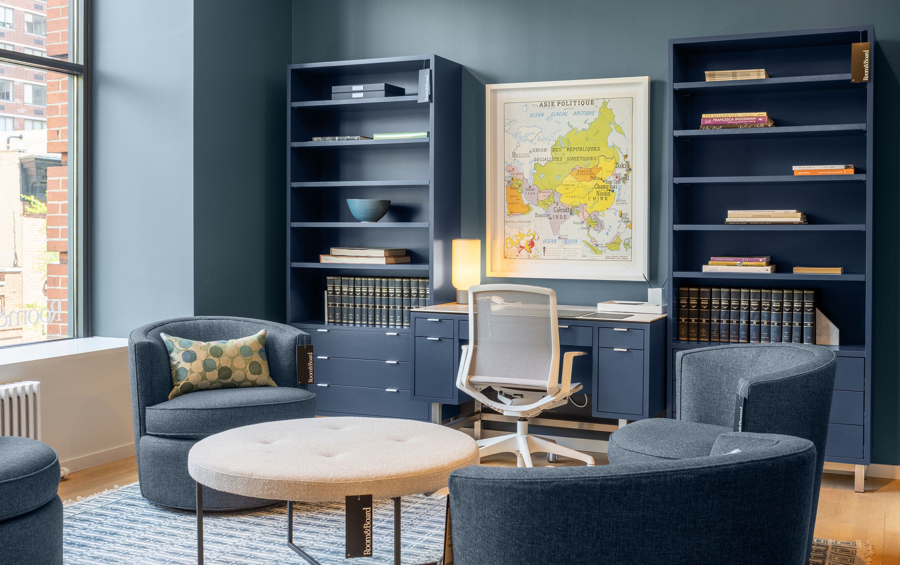 Store photo with 2 Copenhagen bookcases and desk in Navy and a Cynara office chair in white.