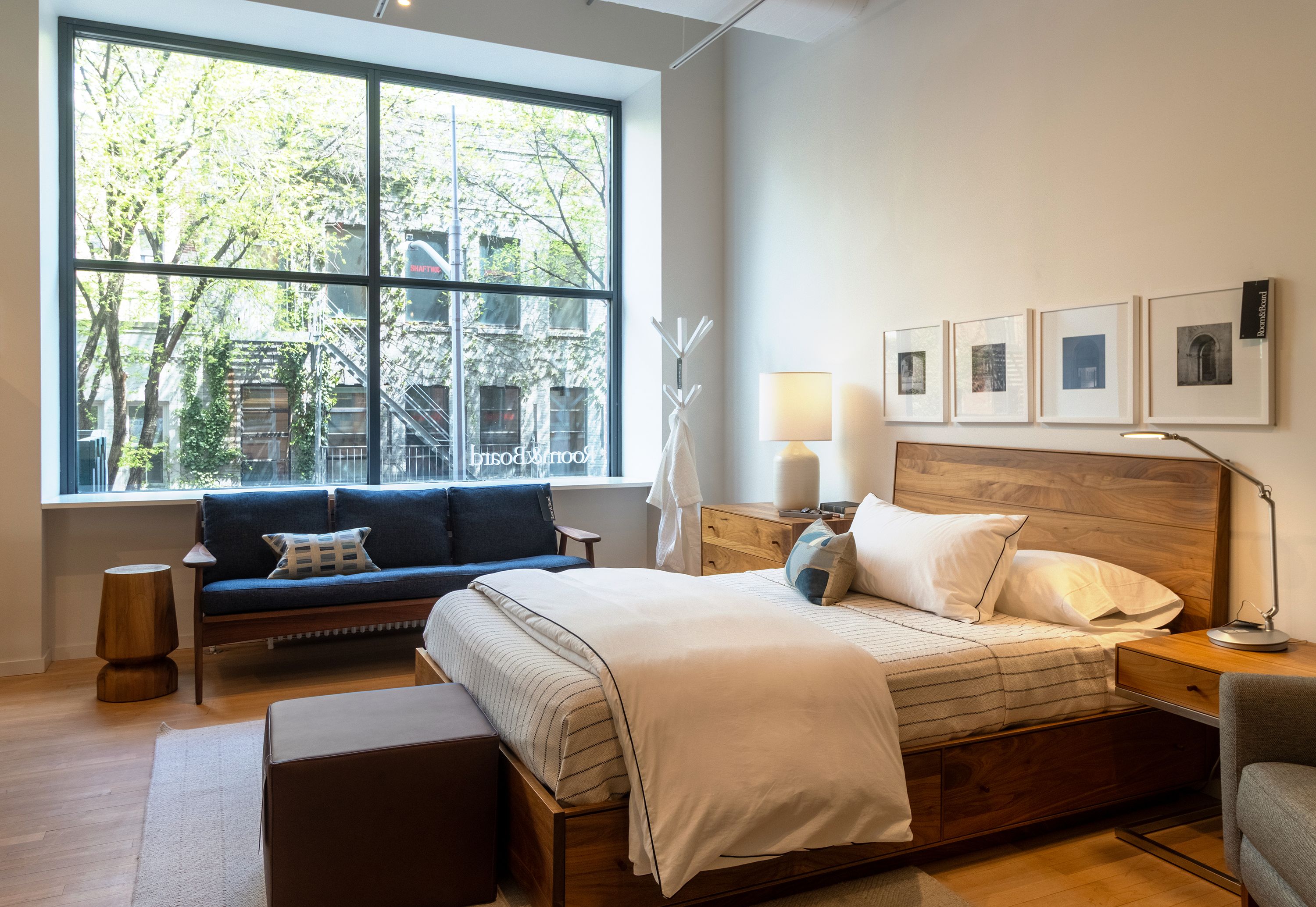 Store image with Hudson queen storage bed and hudson nightstands in walnut and Ericson sofa in Sumner Navy.