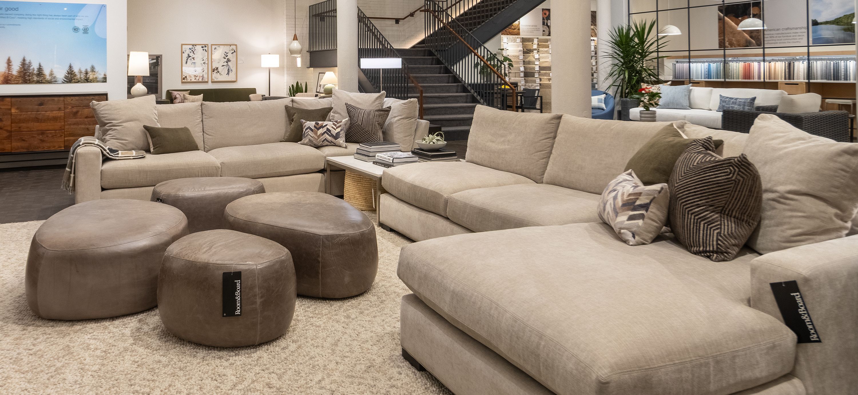 Store image with Metro sectional sofa in Mori Oatmeal and 4 Asher ottomans in Vento Smoke leather.