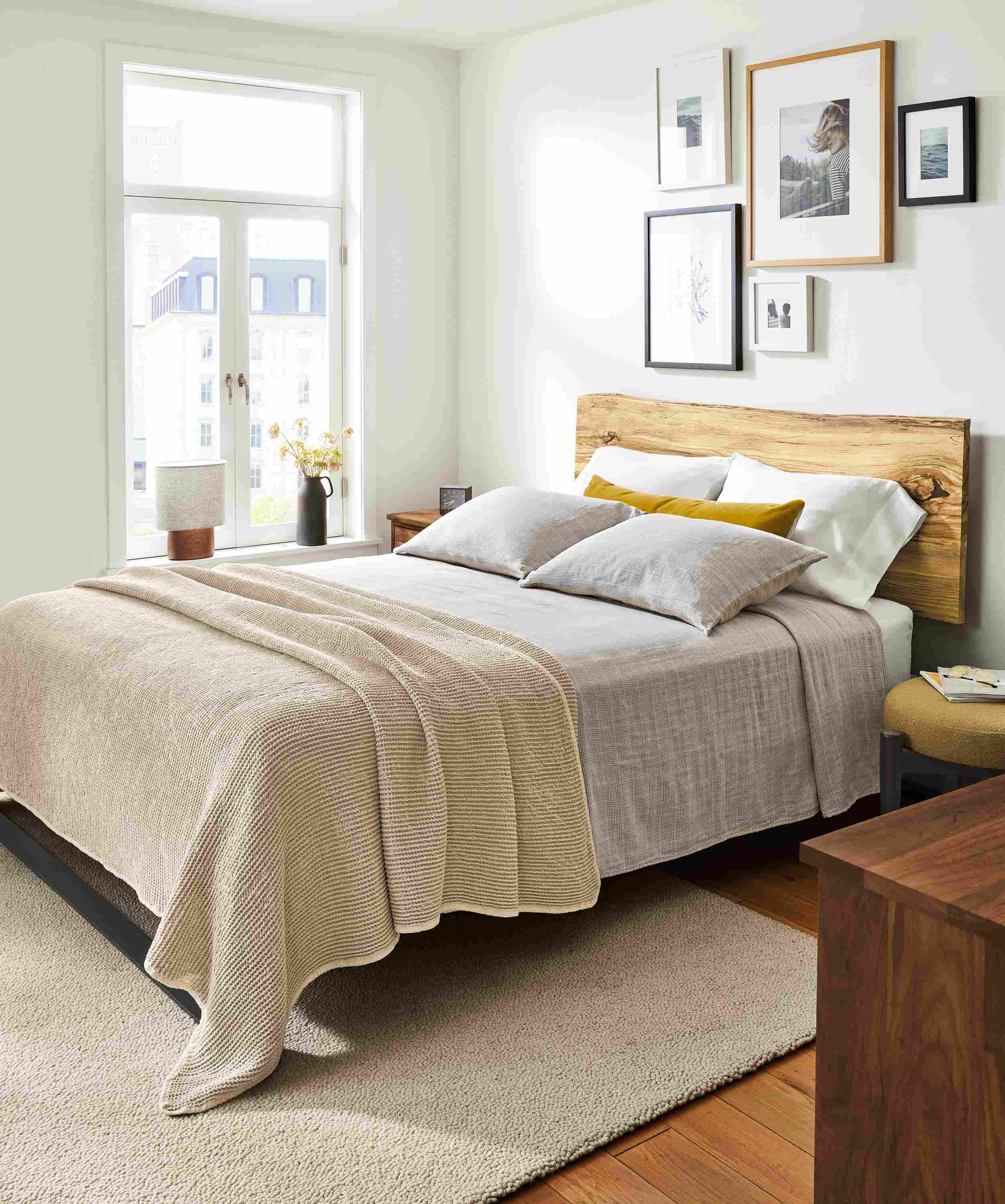 Bedroom with Chilton queen bed in Spalted sugarberry, Emma coverlet, loren coverlet and relaxed linen bedding.