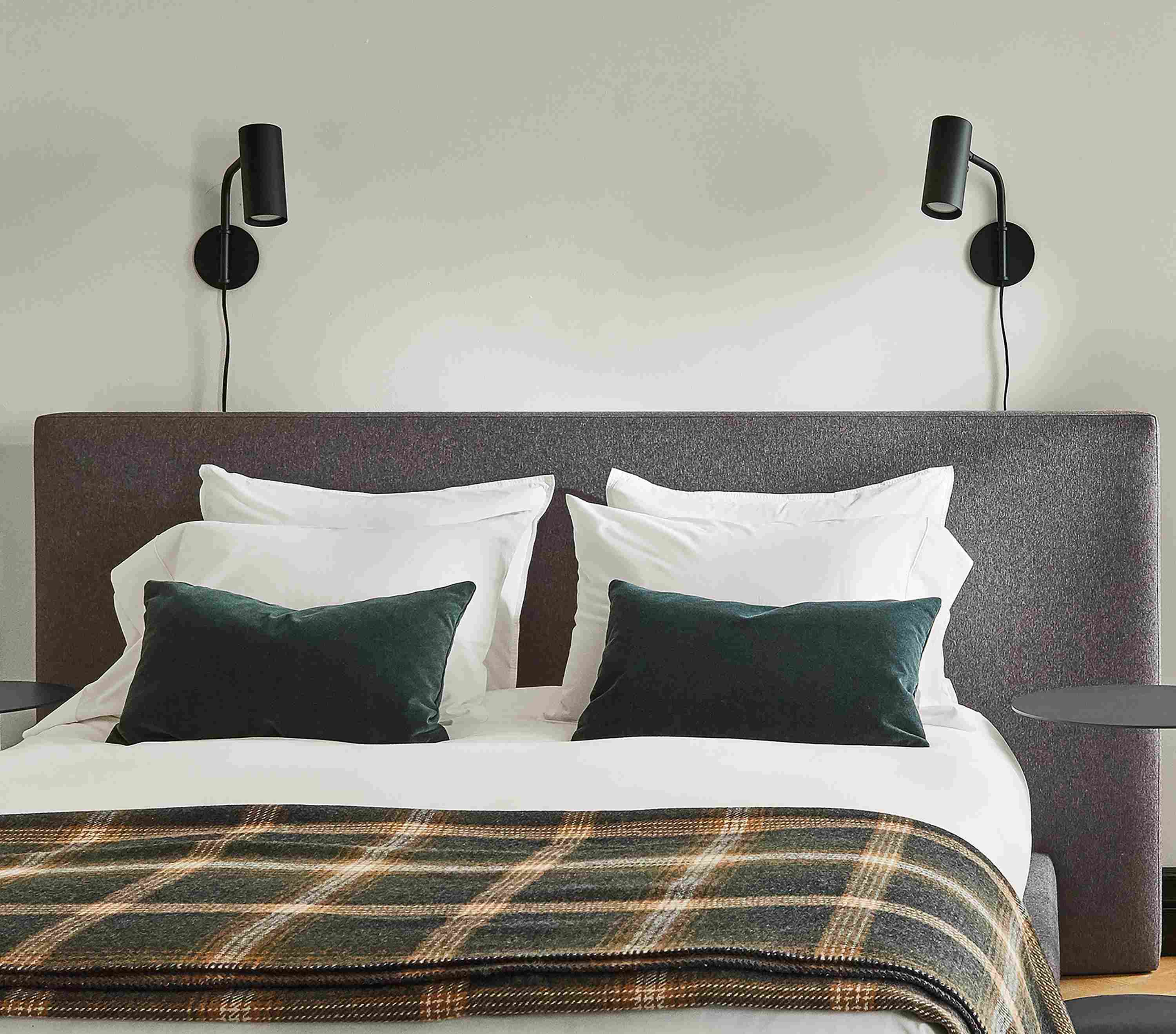 Bedroom setting with a Munro Queen Bed in Flint Fabric and two Eileen Gray Round End Tables on a Hastings Rug.