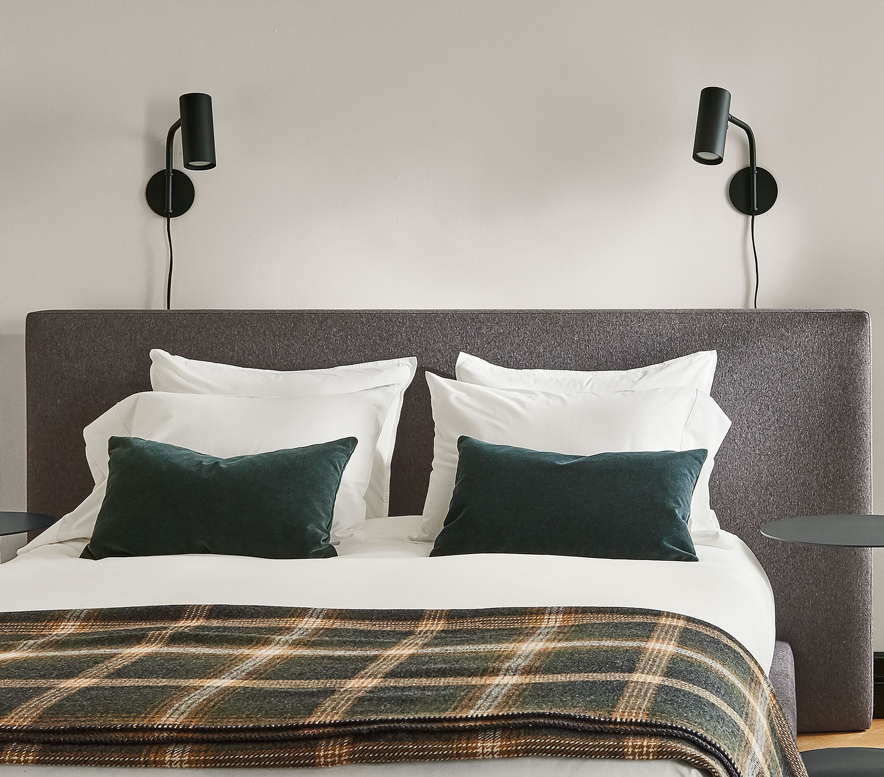 Bedroom setting with a Munro Queen Bed in Flint Fabric and two Eileen Gray Round End Tables on a Hastings Rug.