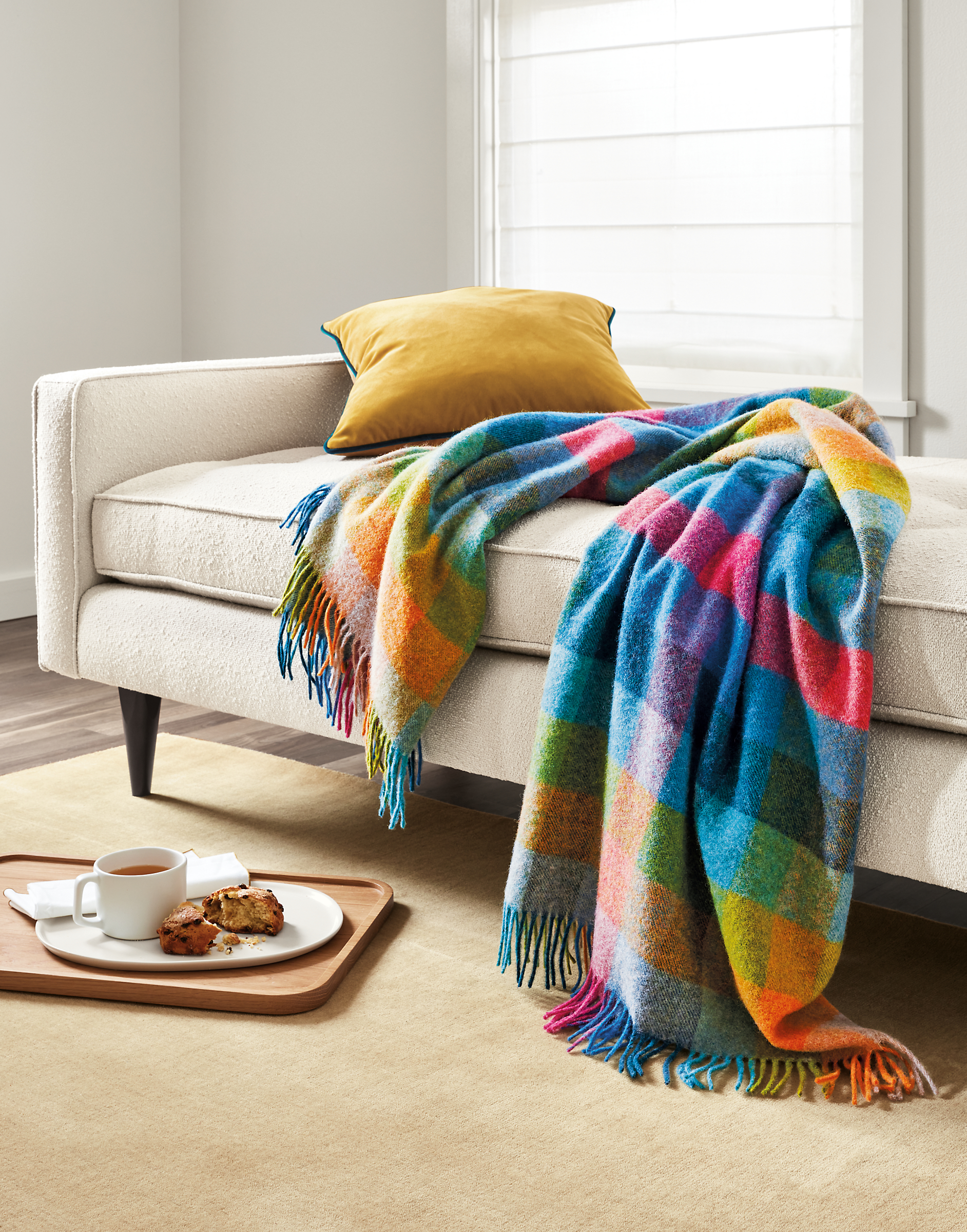 Detail of colorful Clare throw blanket, Reese daybed and Felix pillow in mustard.