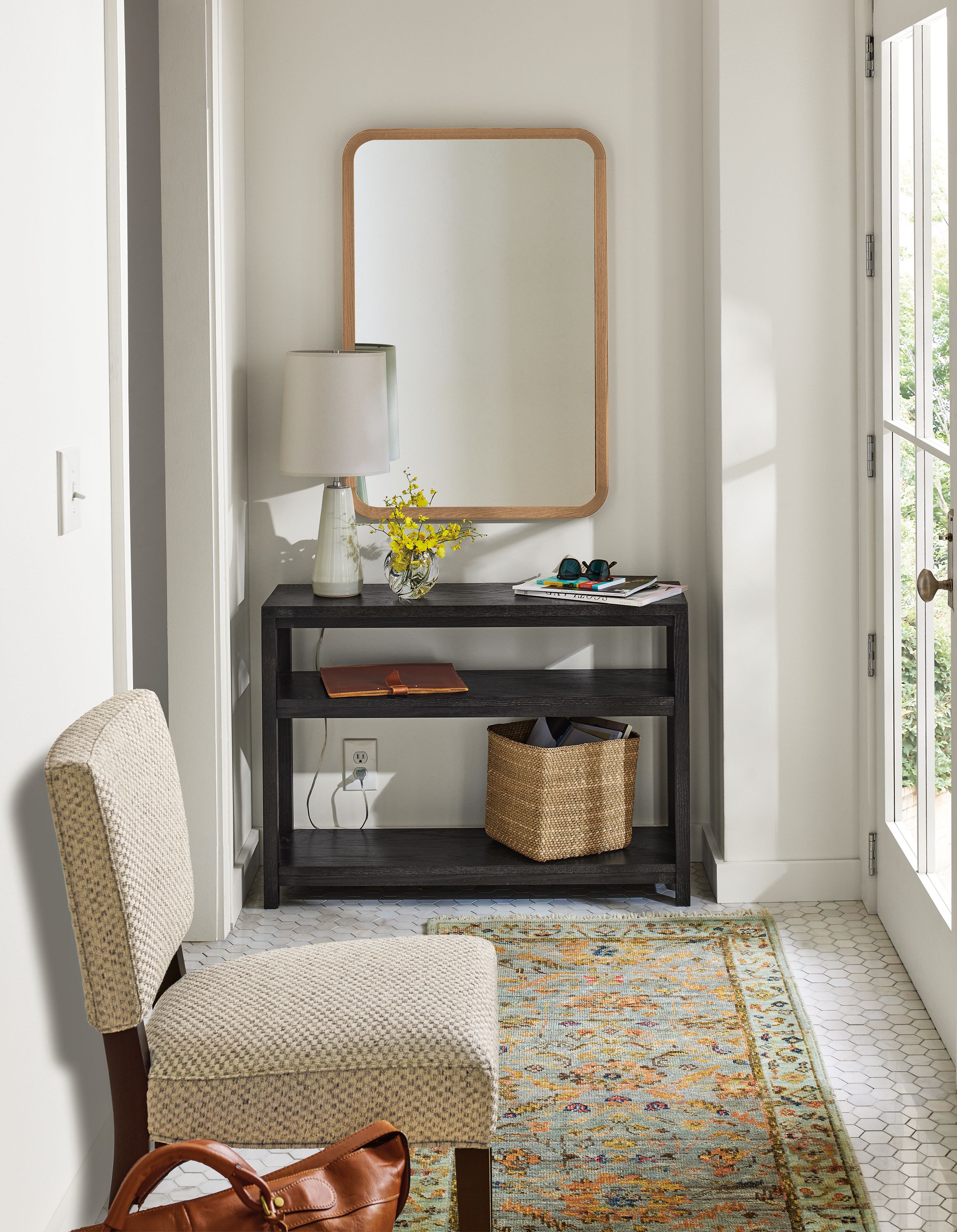 Entryway with clark 38-wide console table in charcoal, georgia side chair in lang grey and sundar rug in sky.