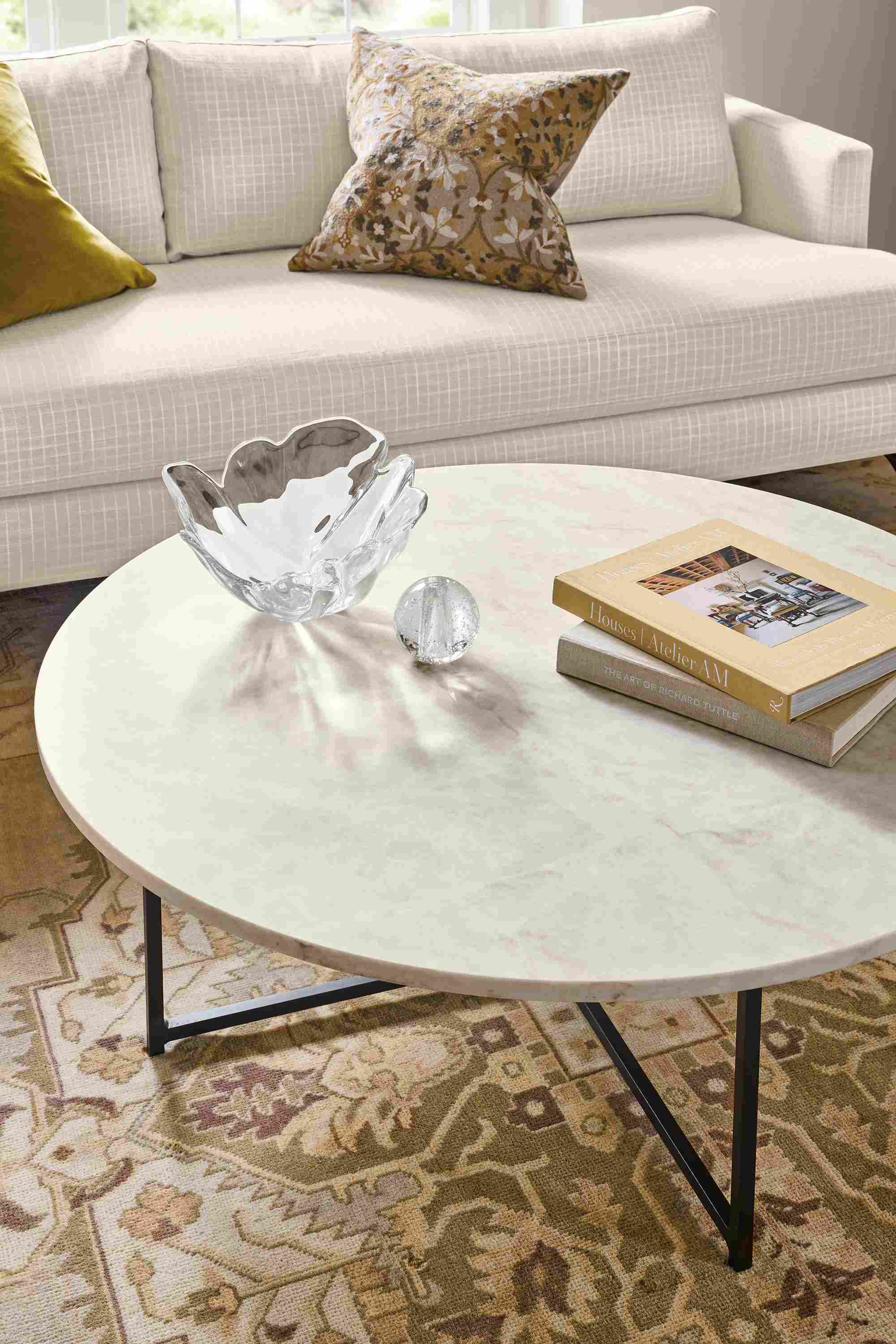 Living room with detail of Classic 42-diameter coffee table in natural steel with Mahal Quartz top.