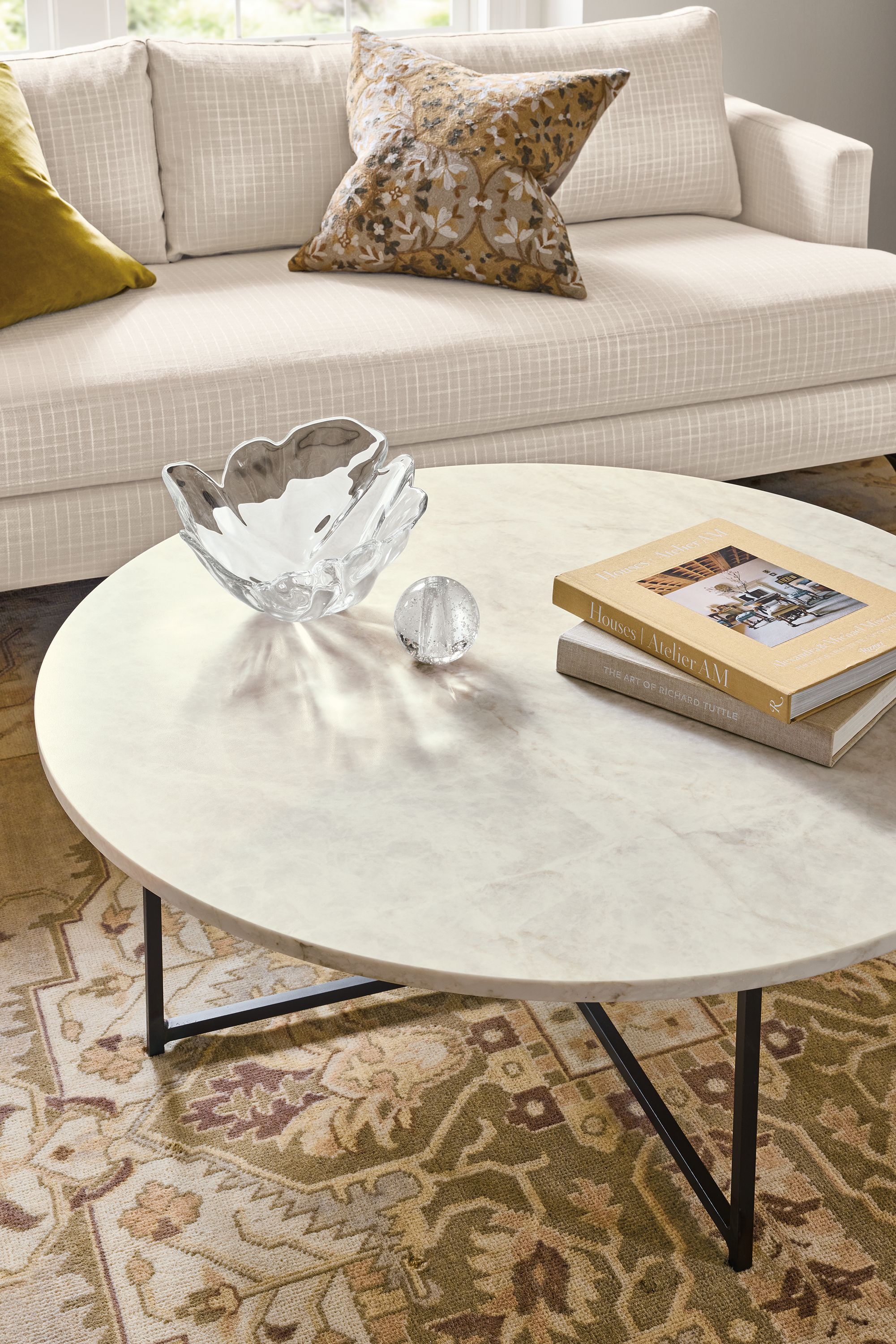 Living room with detail of Classic 42-diameter coffee table in natural steel with Mahal Quartz top.