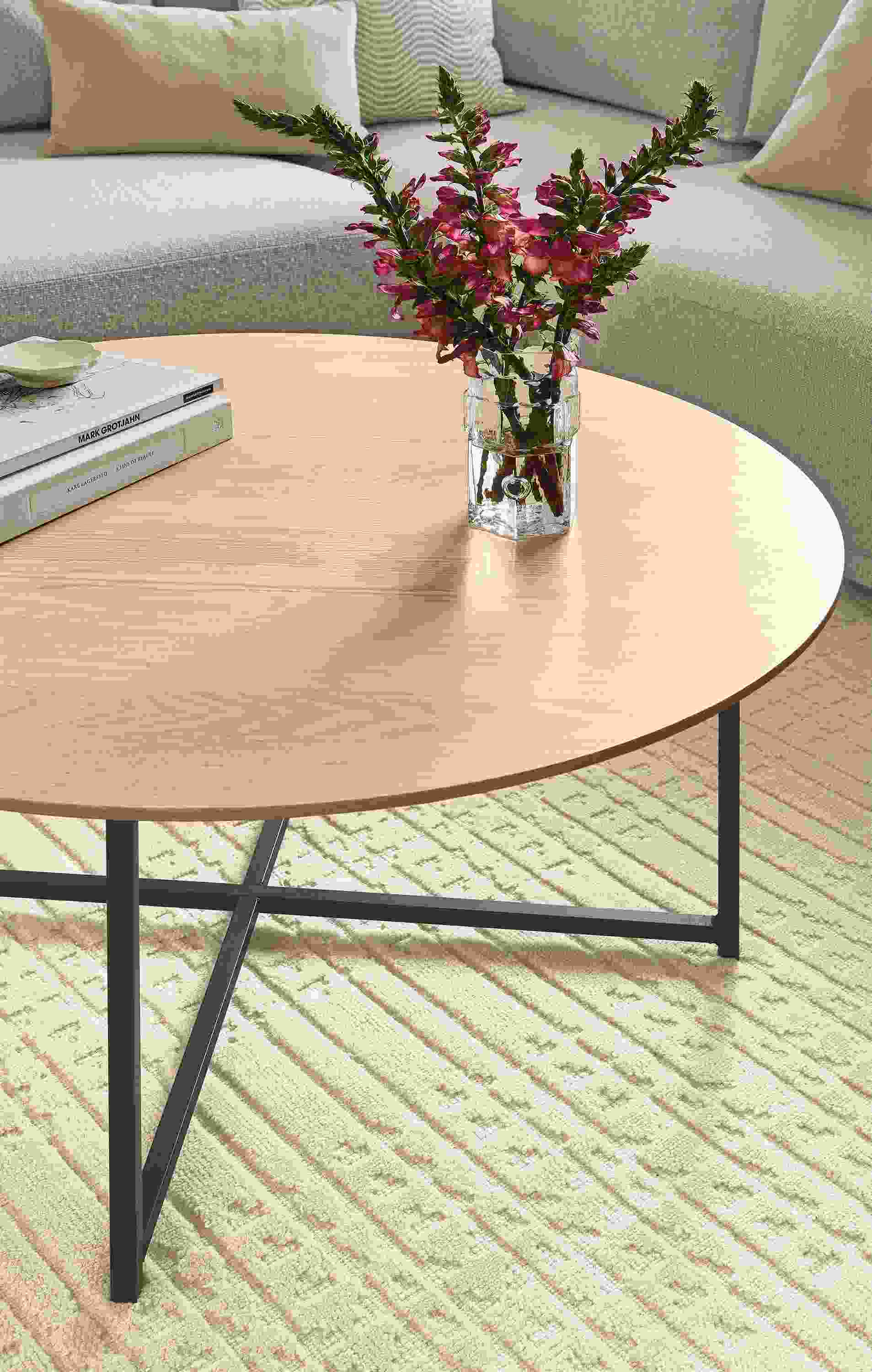 Living room with Classic 36-diameter coffee table in natural steel and salt on rye and Bria rug in Ivory.