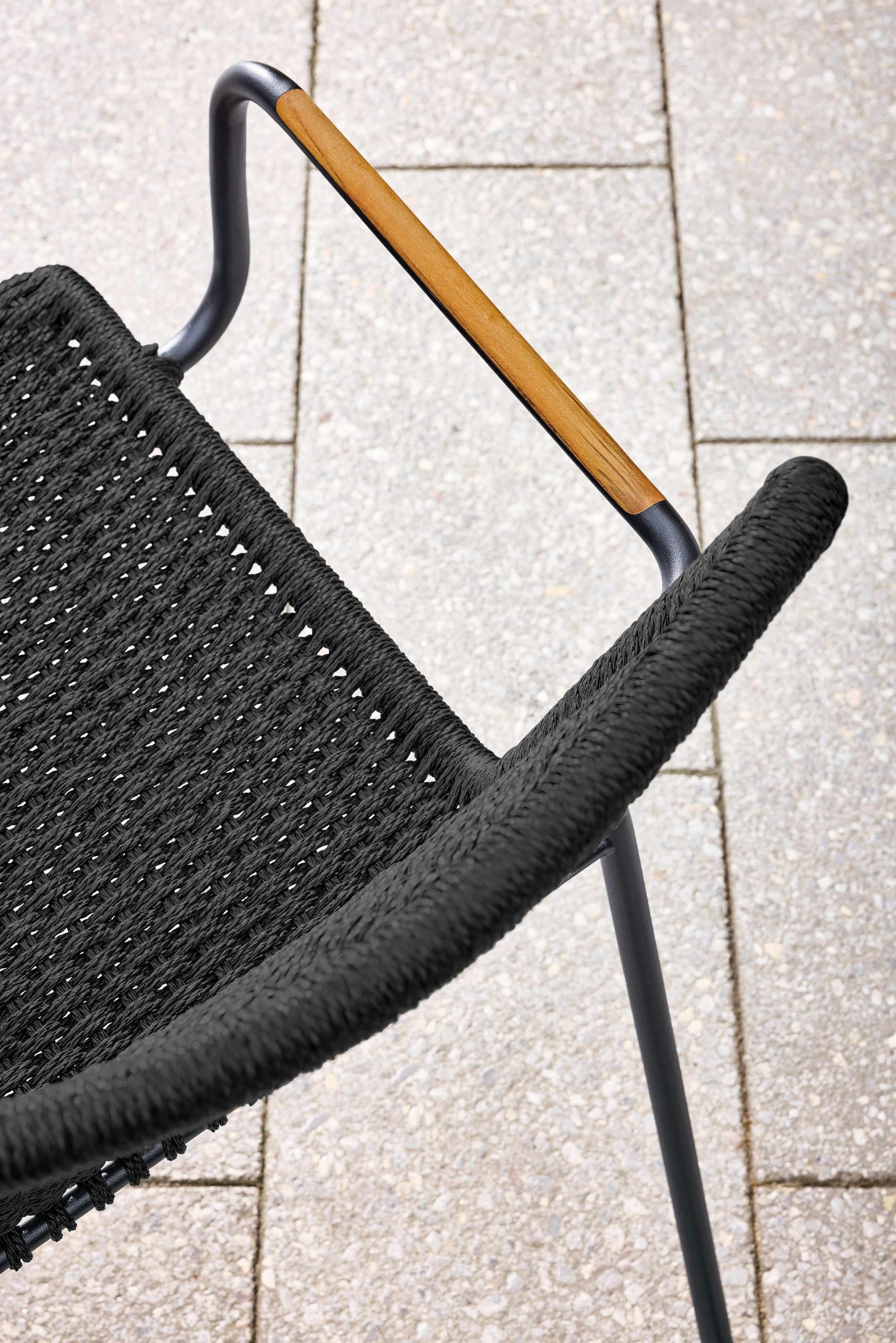 Detail of Clea outdoor arm chair in black with black cording.