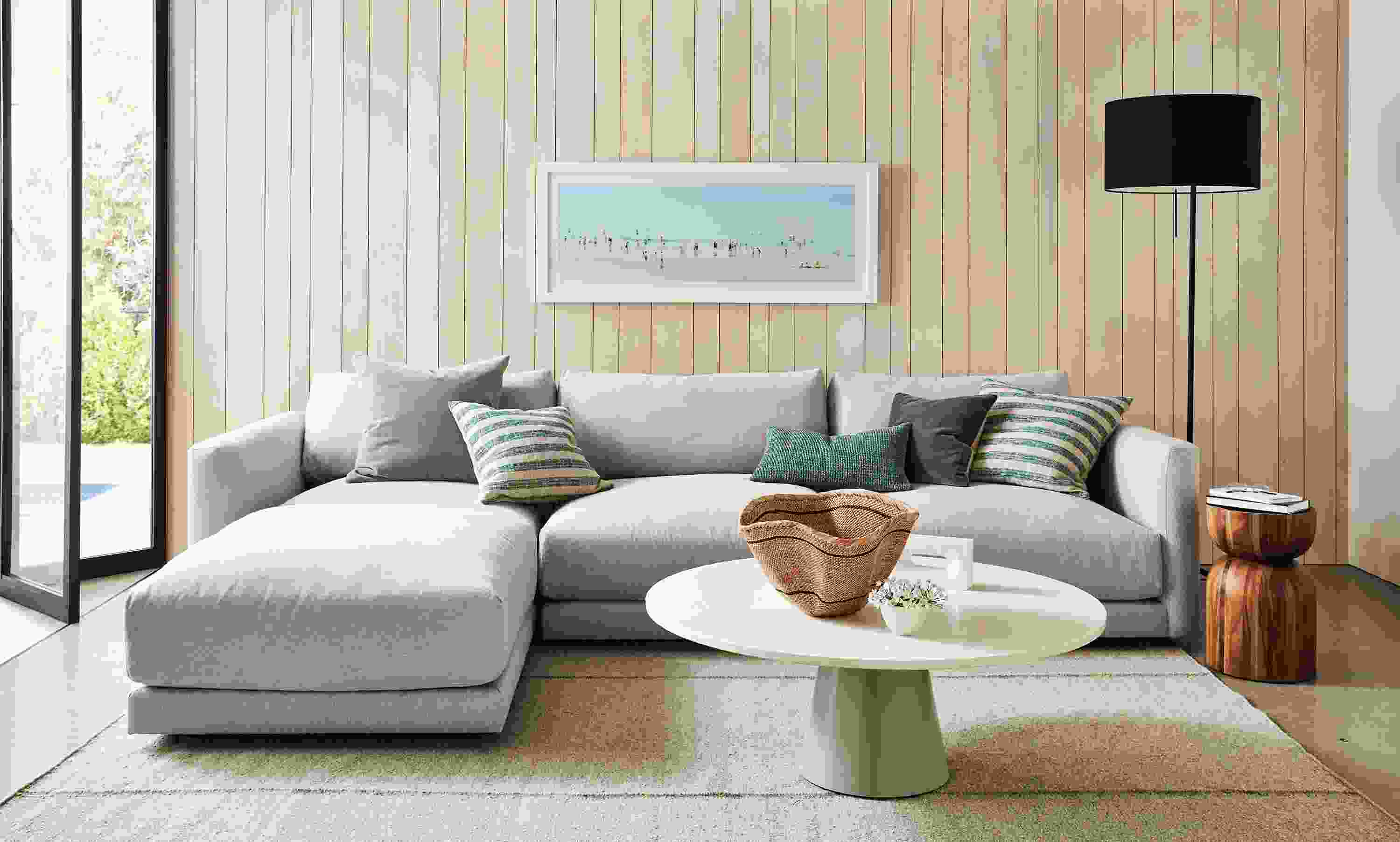 Living room with Clemens four piece modular sofa with ottoman in flint oatmeal.