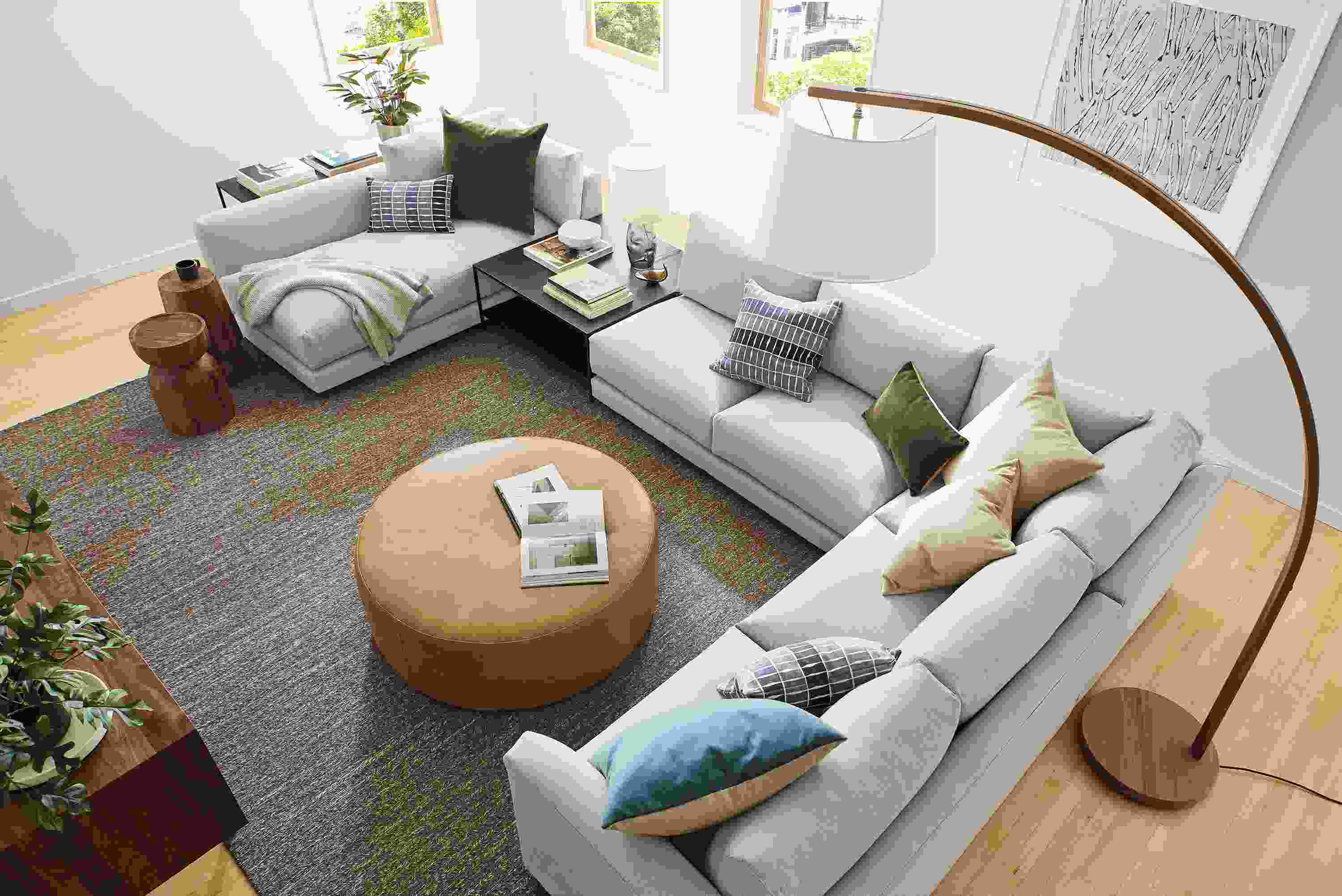 Overhead view Clemens 140-wide sectional with chaise in flint oatmeal, Aero ottoman in Palermo Camel, and Dia rug in foxhound.