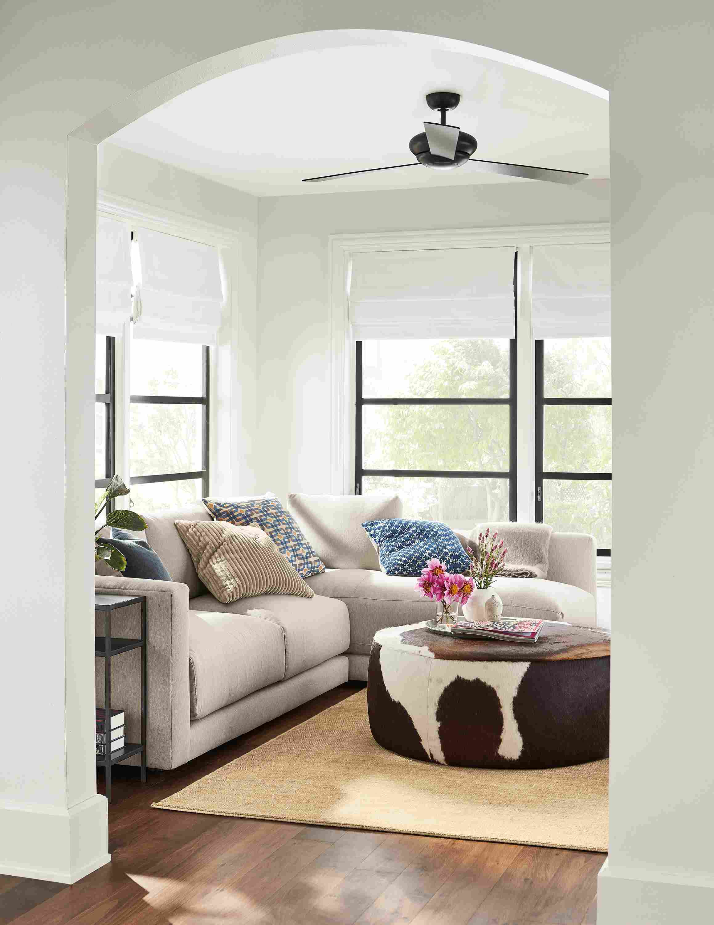 Living room with Clemens sofa in Flint Oatmeal and Lind ottoman in brown cowhide.