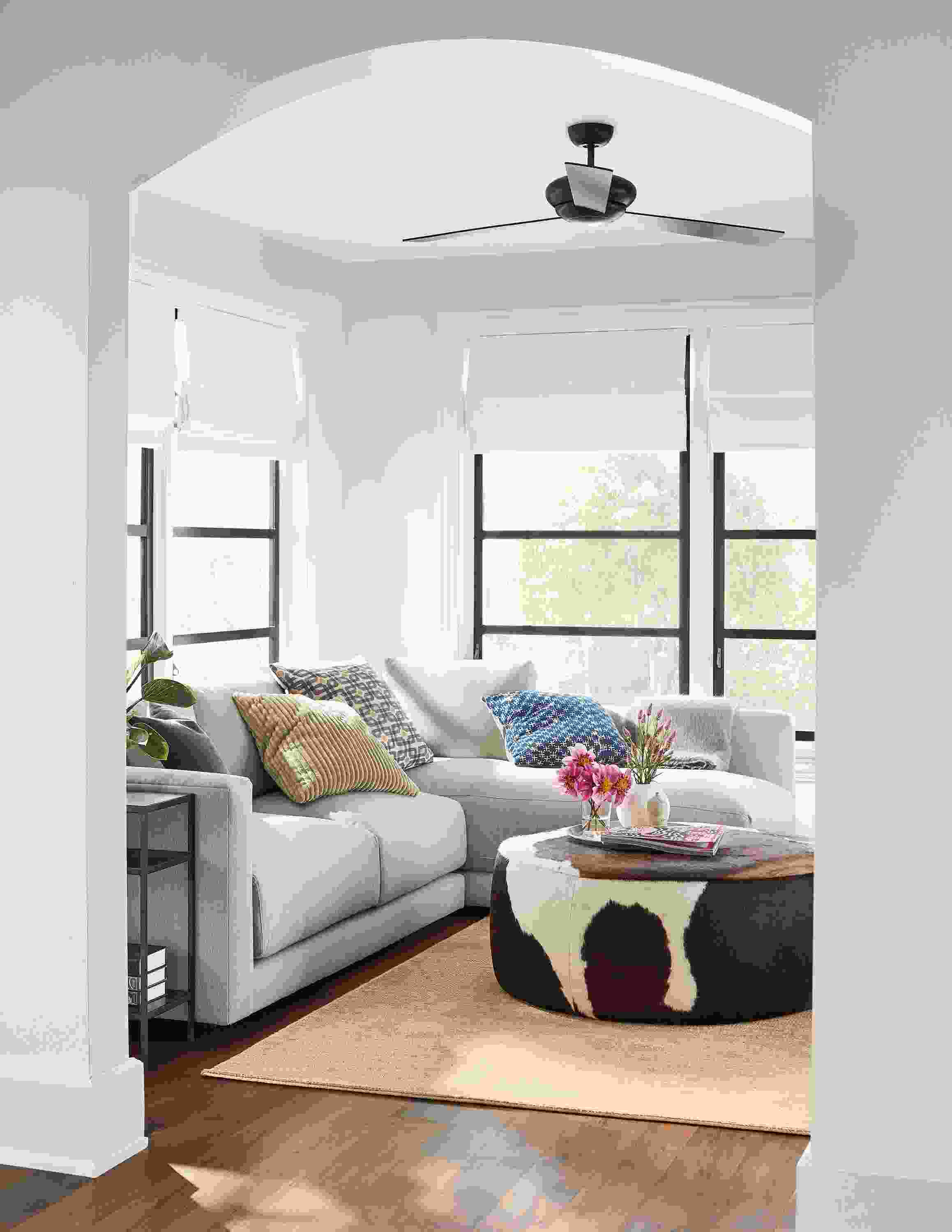 Living room with Clemens sofa in Flint Oatmeal and Lind ottoman in brown cowhide.