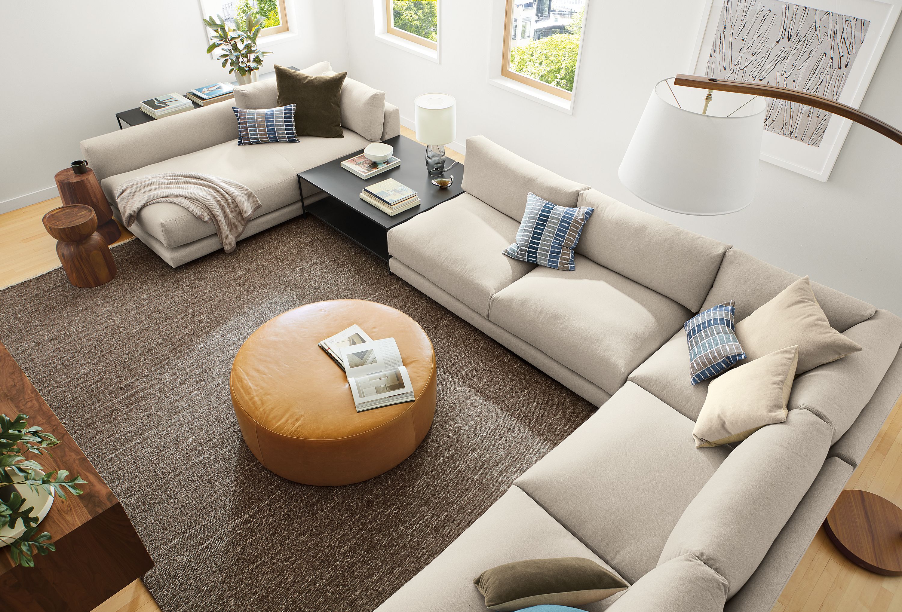 Overhead view of Clemens sectional in flint oatmeal, Aero ottoman in Vento Camel and Slim coffee table in Natural Steel.