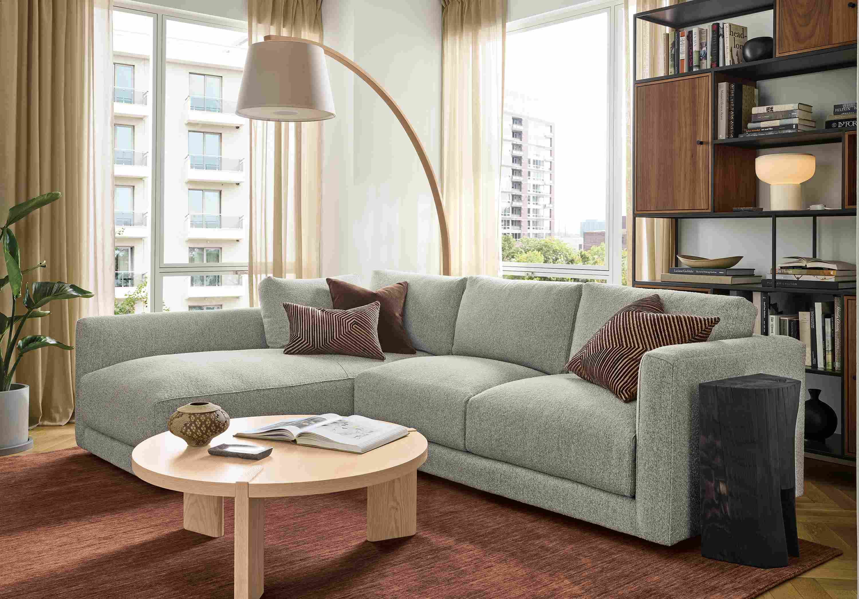 Living room with Clemens 104-wide sofa in Conley Grey and Hanover 36-diameter coffee table in salt on red oak.