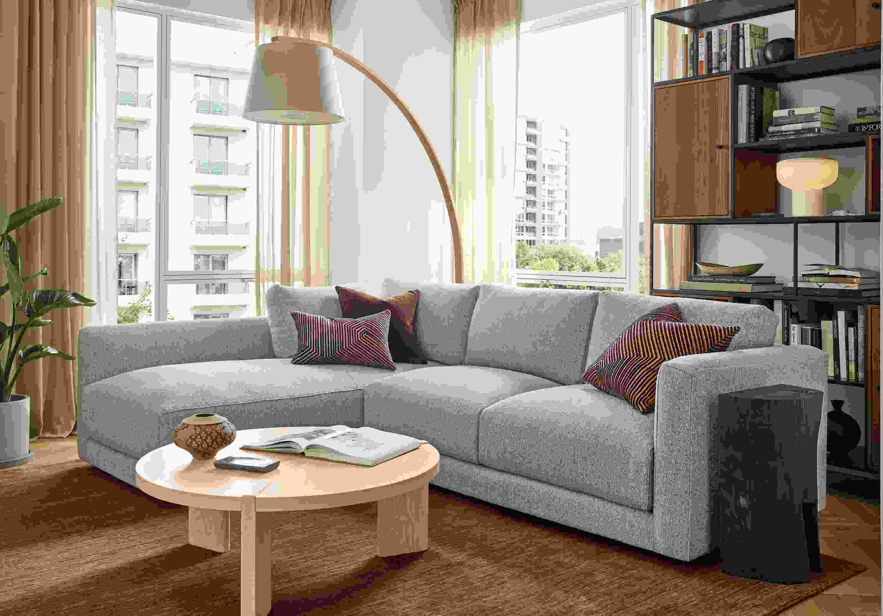 Living room with Clemens 104-wide sofa in Conley Grey and Hanover 36-diameter coffee table in salt on red oak.