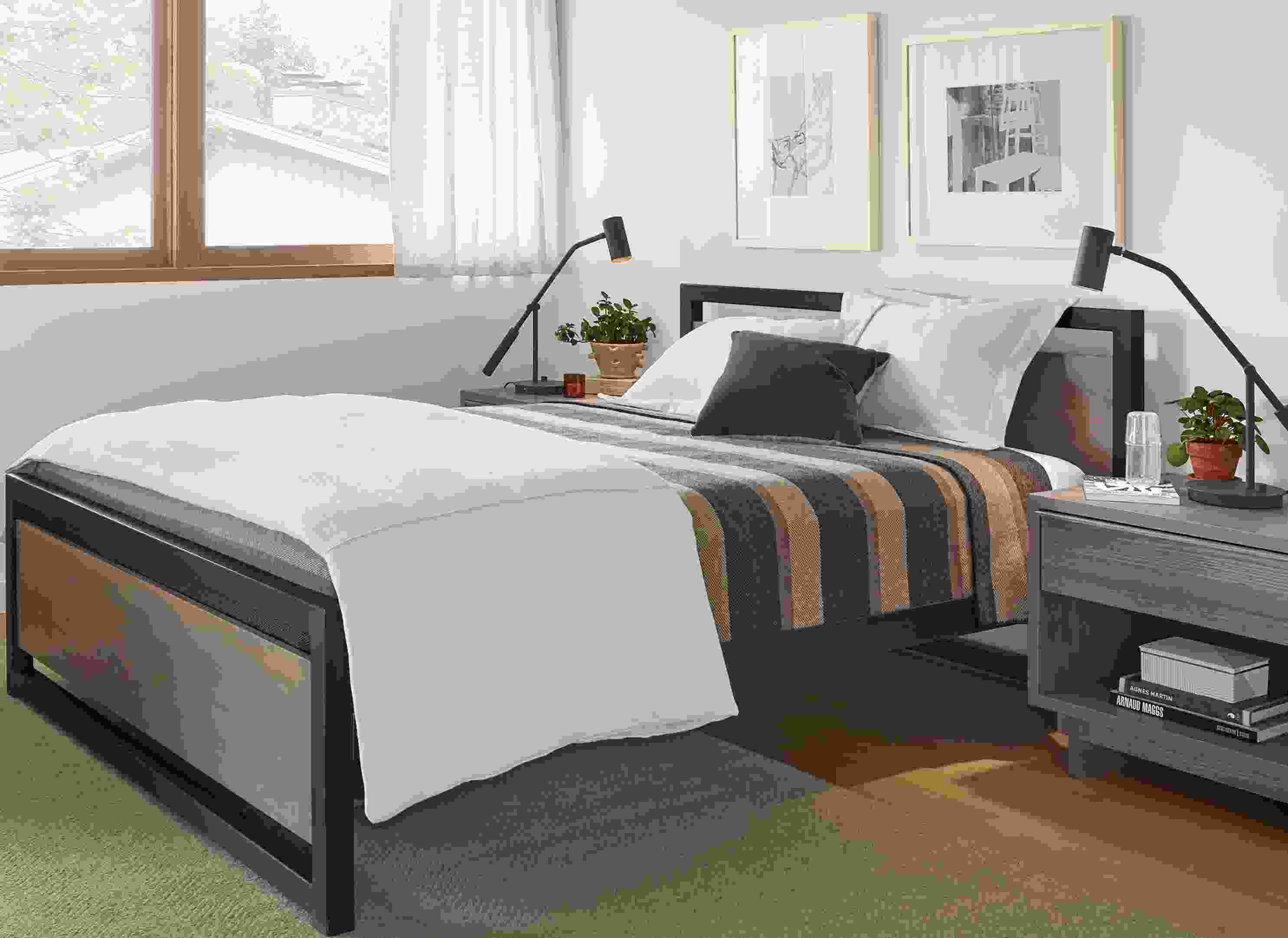 Detail of Piper queen bed in small bedroom with Otis swivel chair.