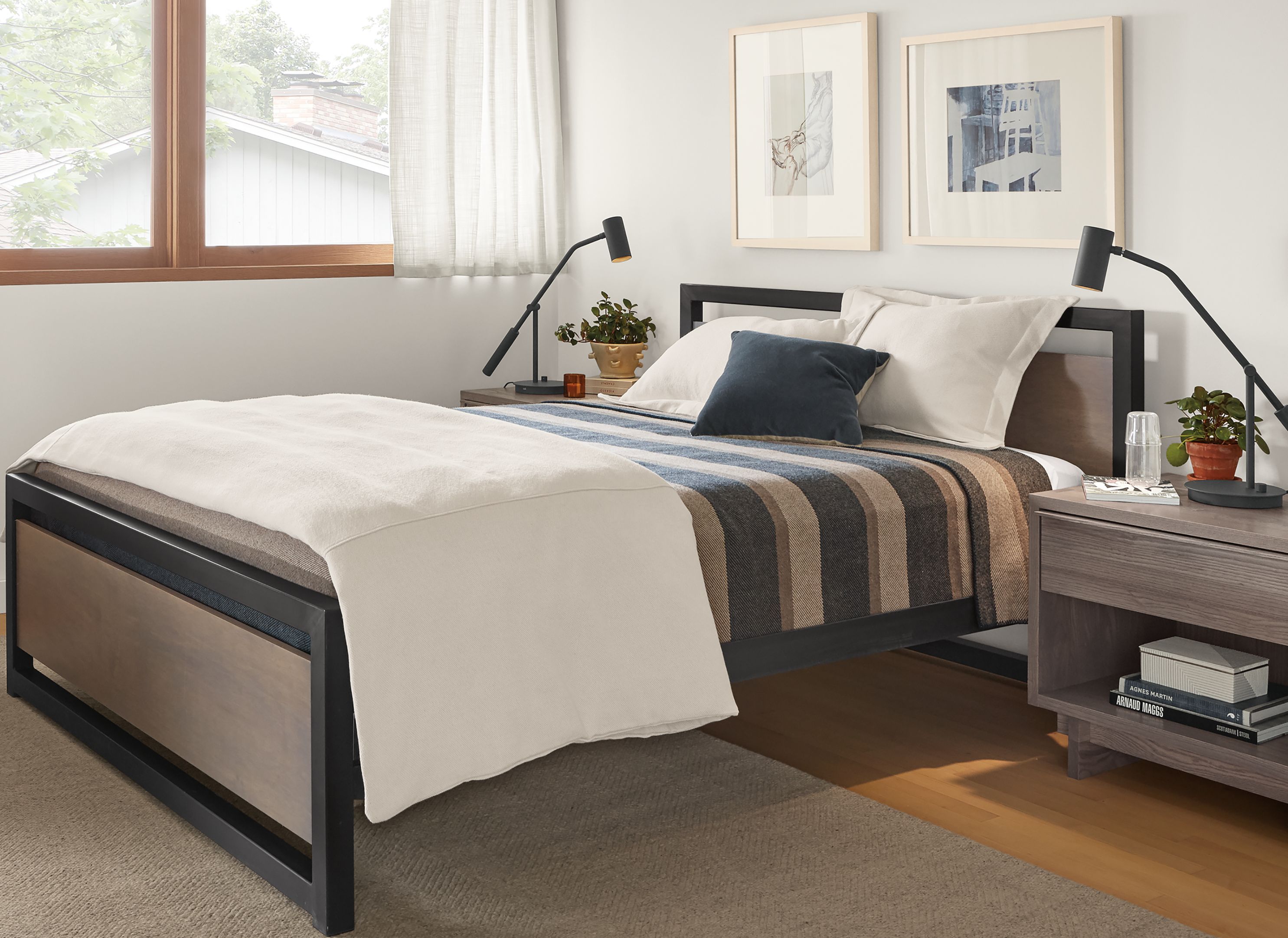 Detail of Piper queen bed in small bedroom with Otis swivel chair.