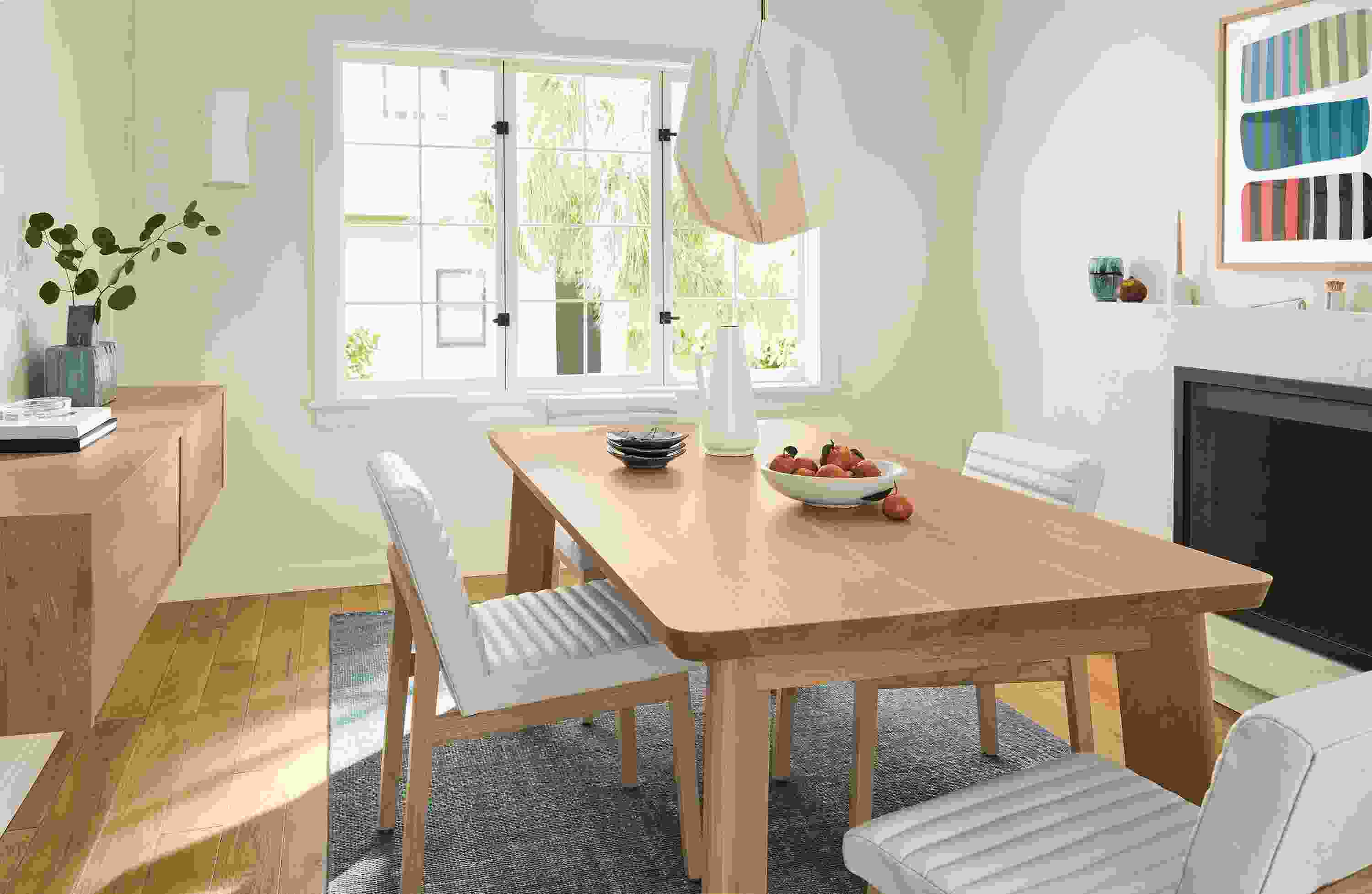 Dining room with Colby table in Rye and Olsen side chair in Laino Bone leather and Samar rug in haze.