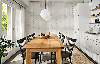 dining room with colby table in white oak, thatcher side chairs in charcoal, orbit pendants.