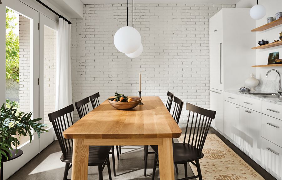 dining room with colby table in white oak, thatcher side chairs in charcoal, orbit pendants.