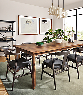 large dining room with colby table and evan chairs in charcoal with cushion.