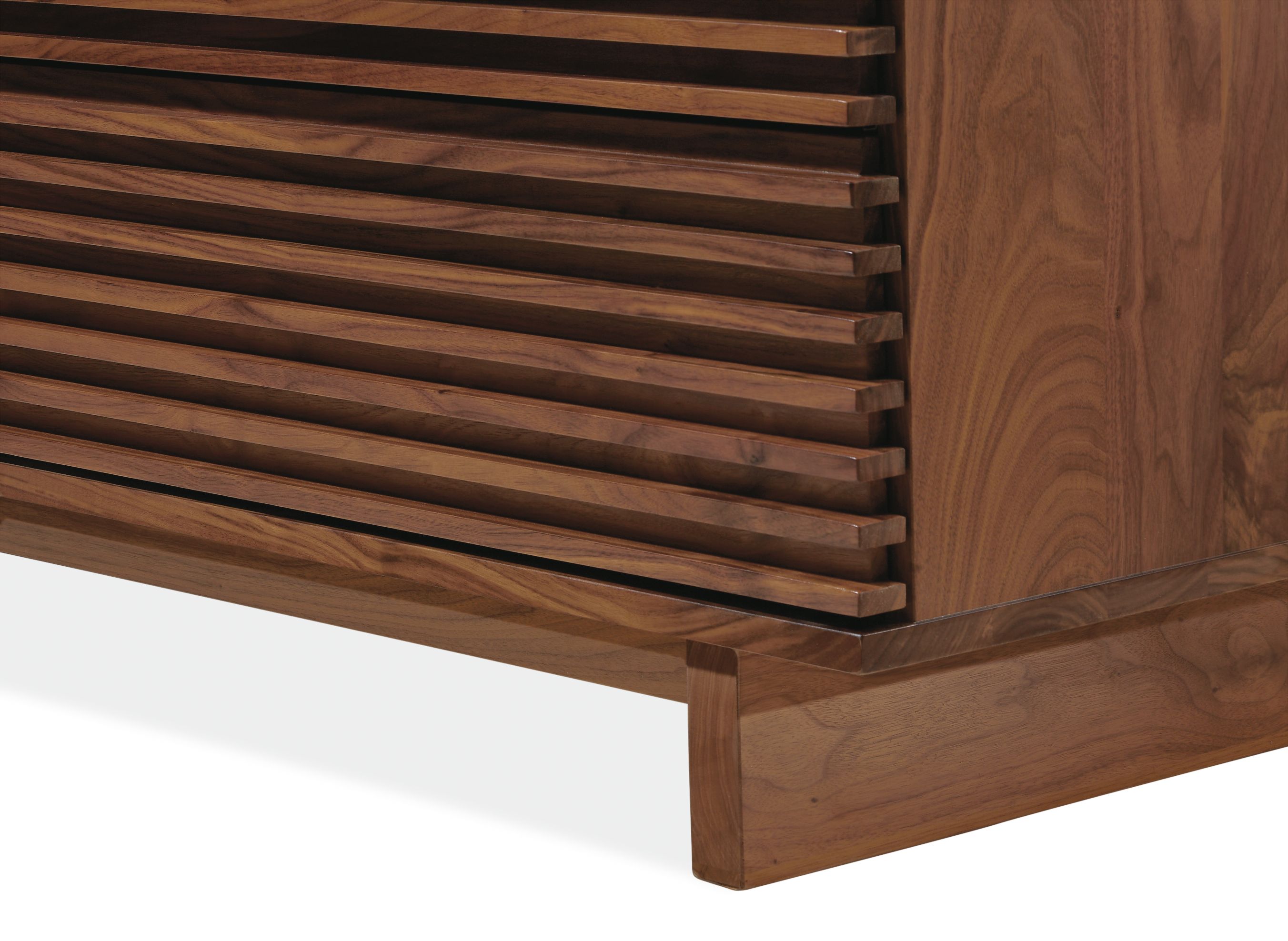 Close-up of bottom corner of Coles 72-wide ten-drawer dresser in walnut.