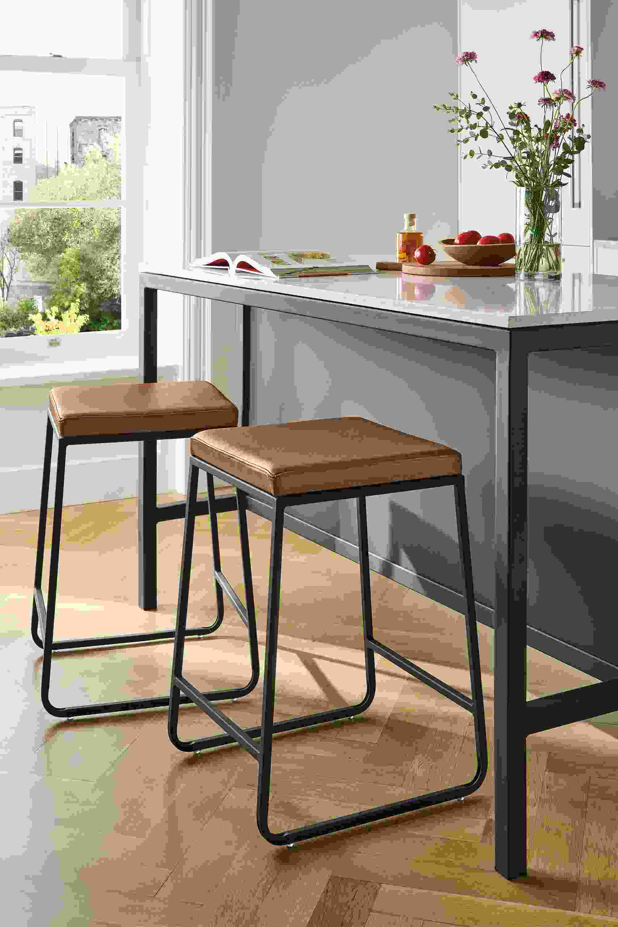 Kitchen with 2 Collins counter stools in Pesaro Cognac leather and Parsons 60-wide narrow shelf counter in graphite.