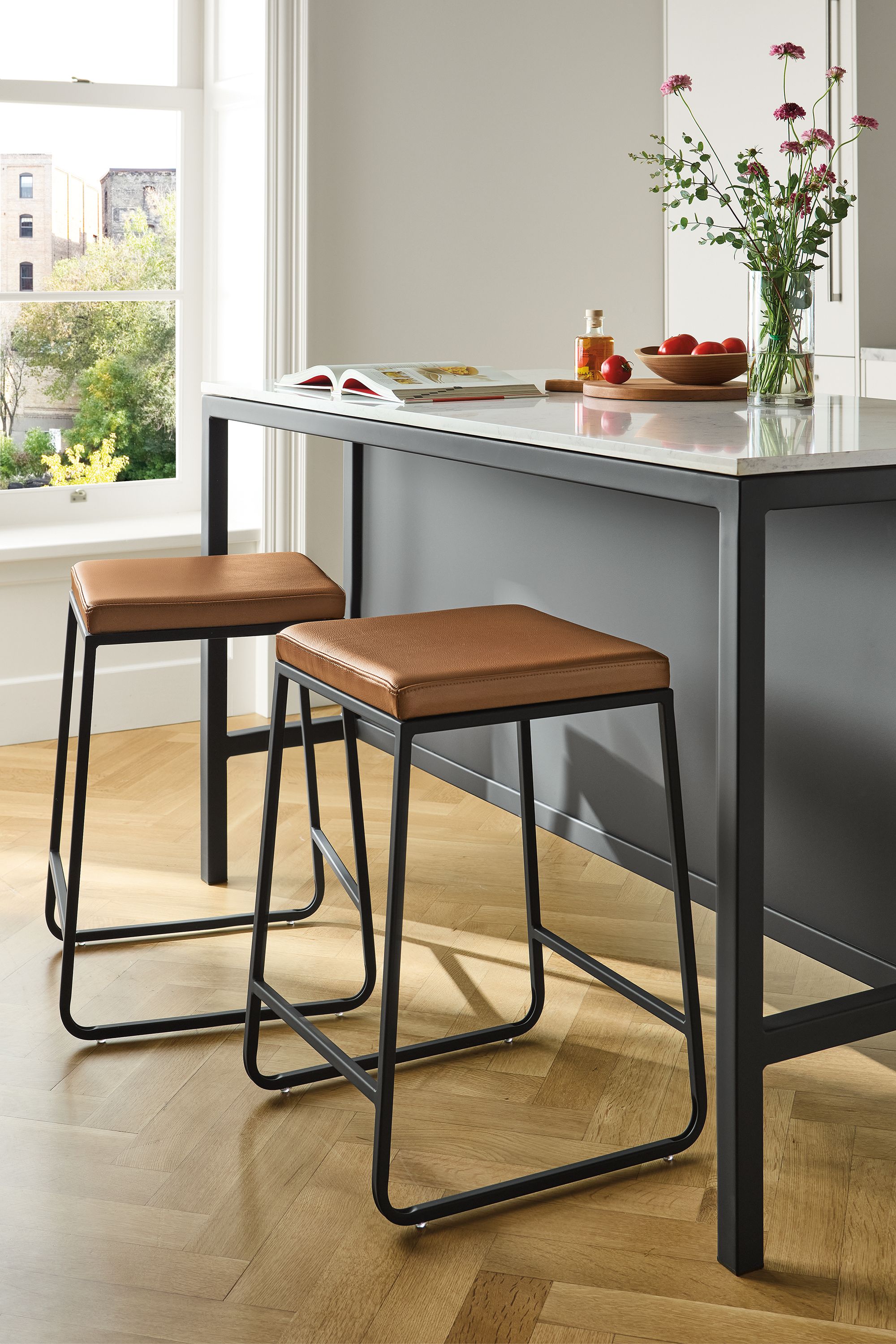 Counter stool in Pesaro cognac leather with graphite base