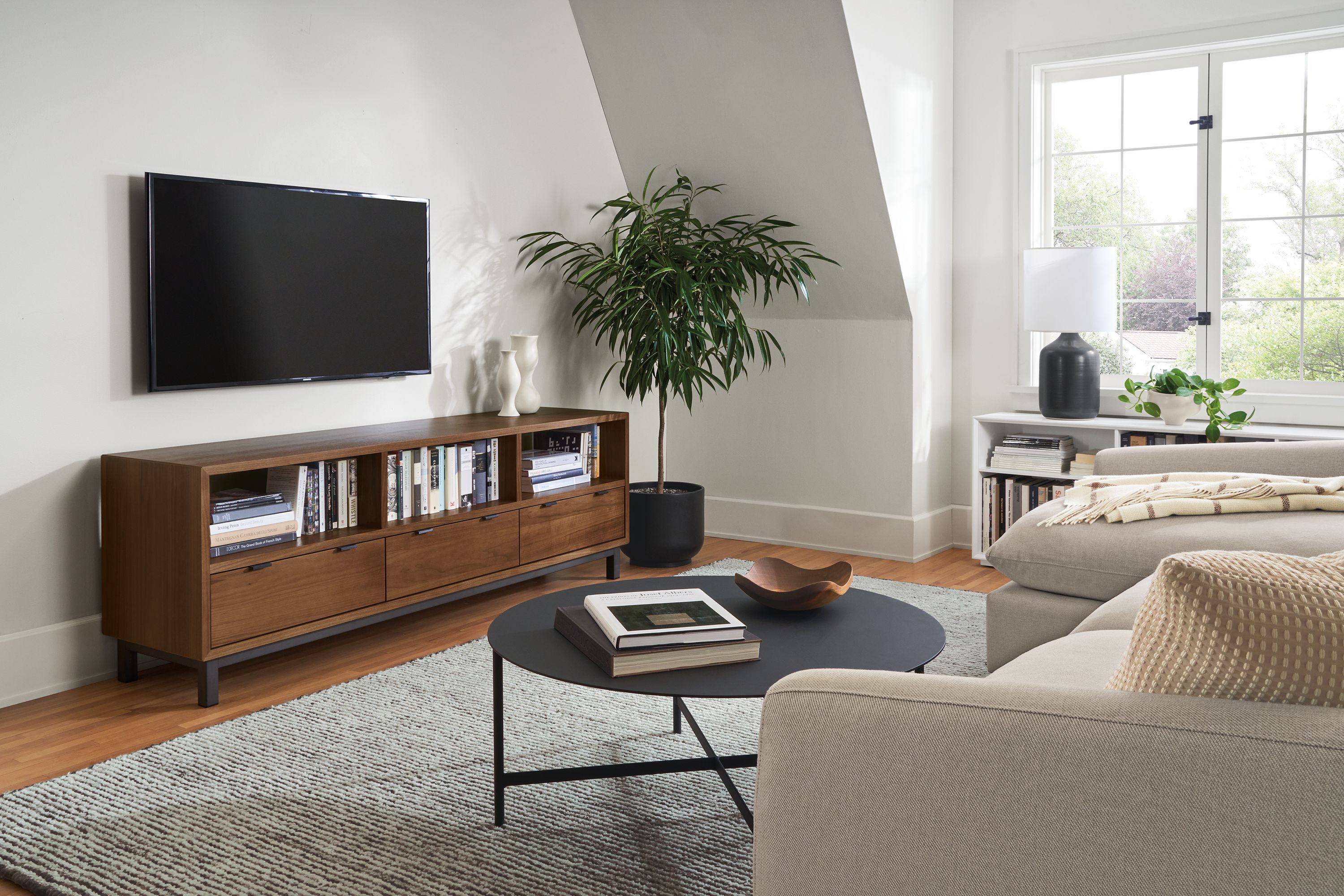 living room with copenhagen media cabinet, circuit coffee table, weber chair.