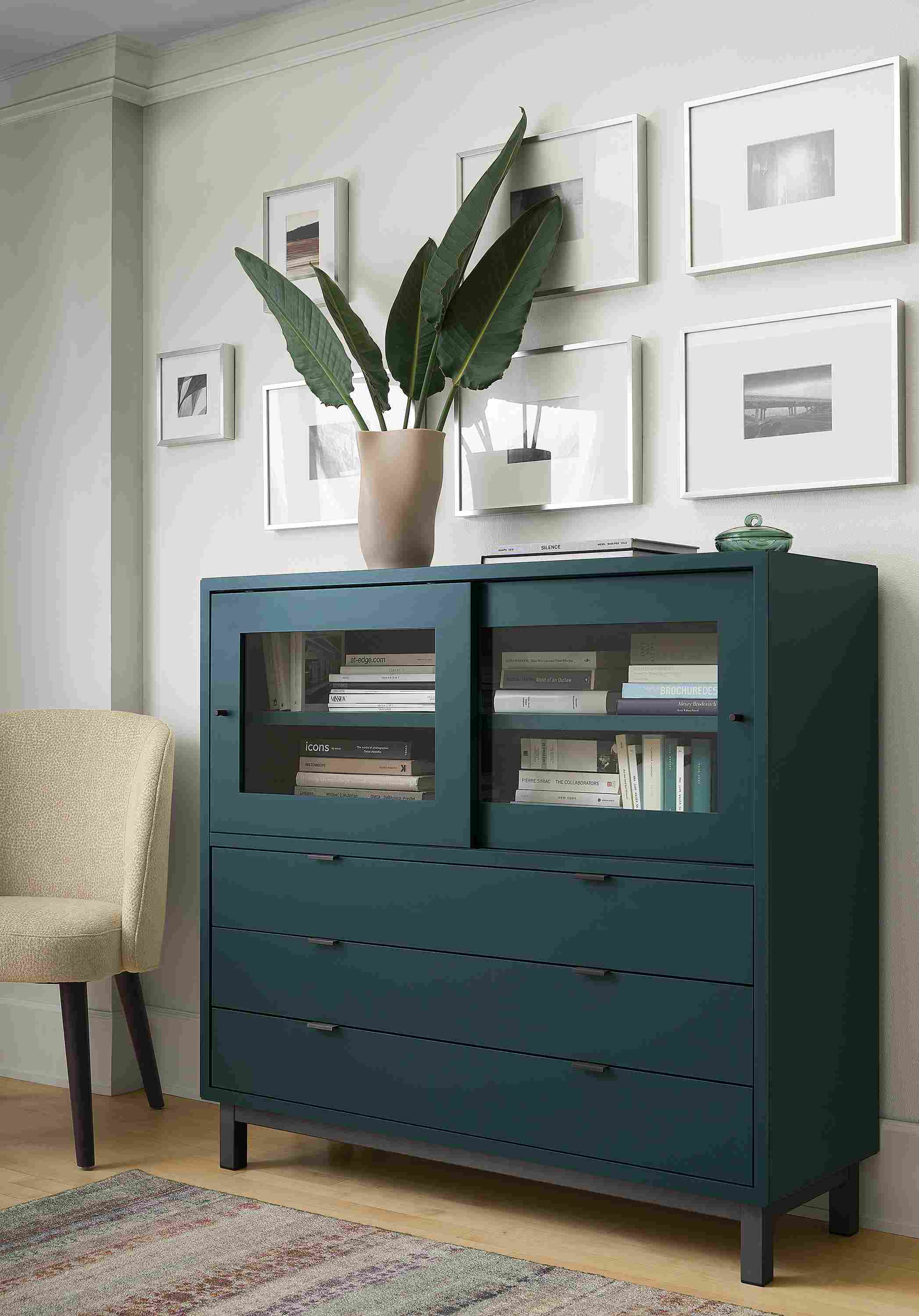 Living room with Copenhagen 47-wide 4-insert cabinet in slate, Cora side chair in Faron Oatmeal and Varun rug in multicolor.