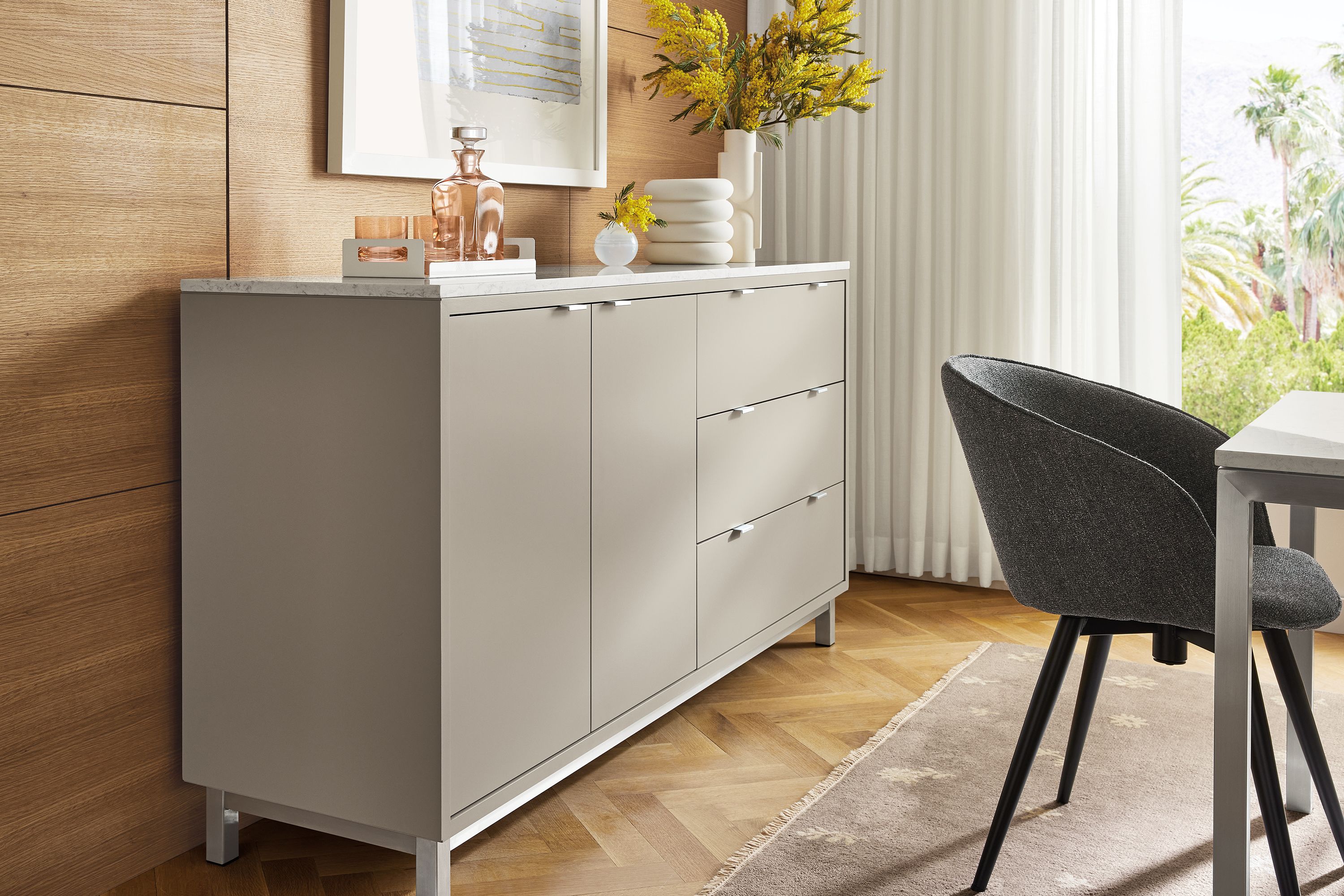 Dining area with Copenhagen 72-wide cabinet in taupe with Marbled white quartz top, Parsons table and Sylvan swivel chair.