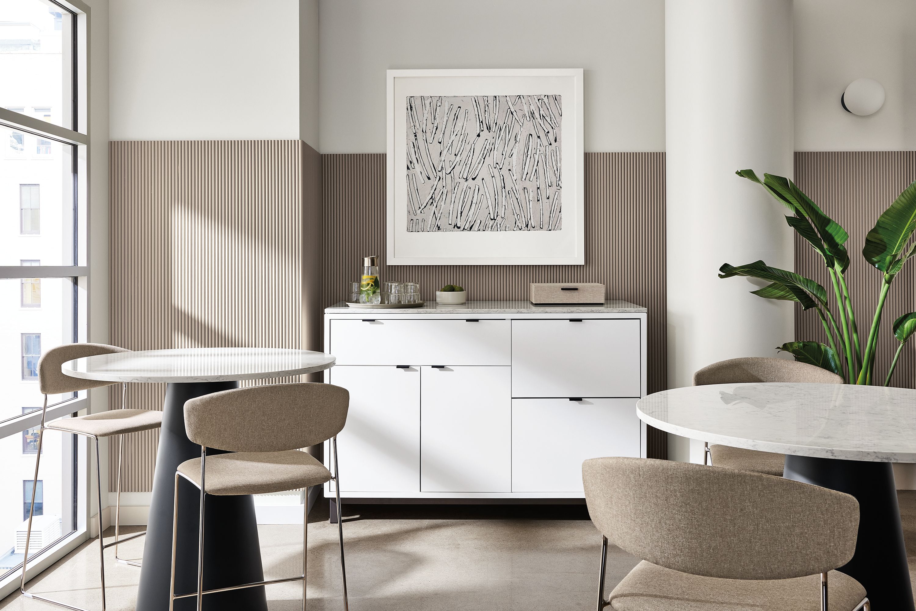 office dining space with decker tables, wolfgang chairs, copenhagen fridge cabinet.