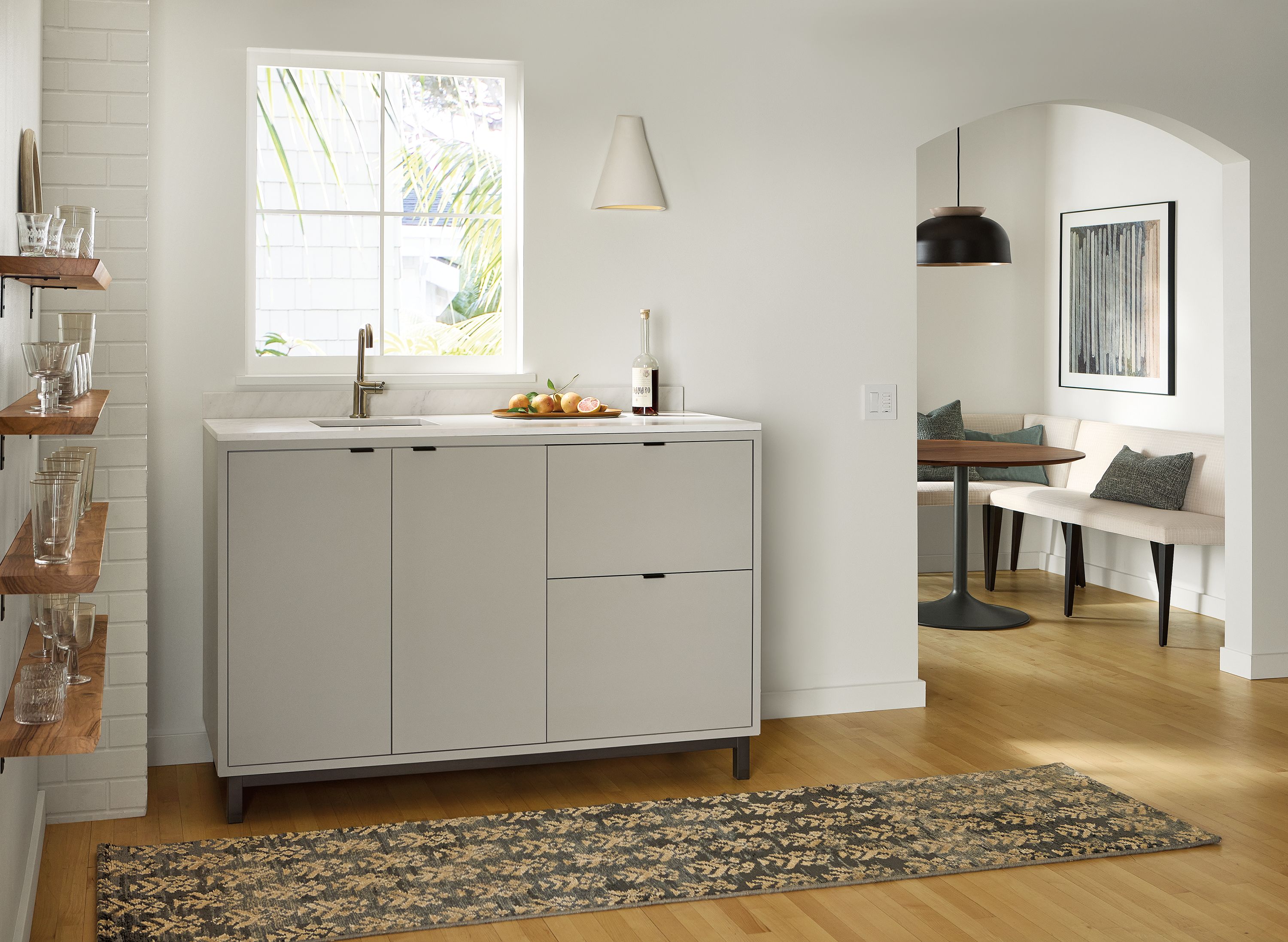 Home bar area with a Copenhagen wet bar fridge cabinet with sink top in taupe and Layla runner in forest.