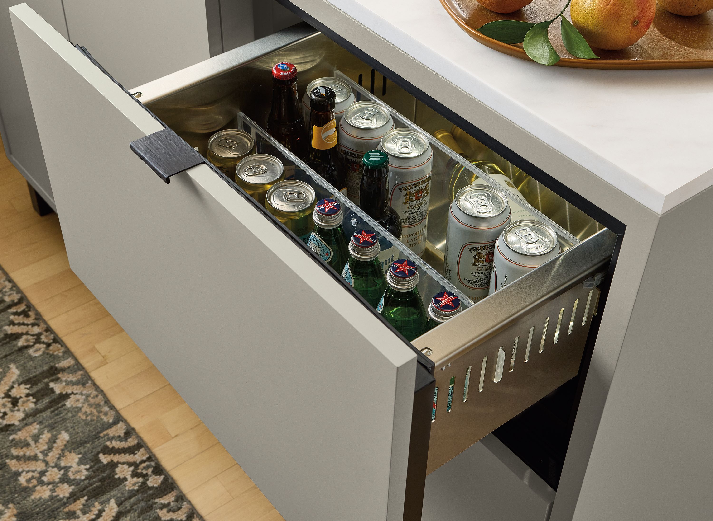 Detail shot of an open refrigerator drawer on a copenhagen wet bar fridge cabinet in taupe.