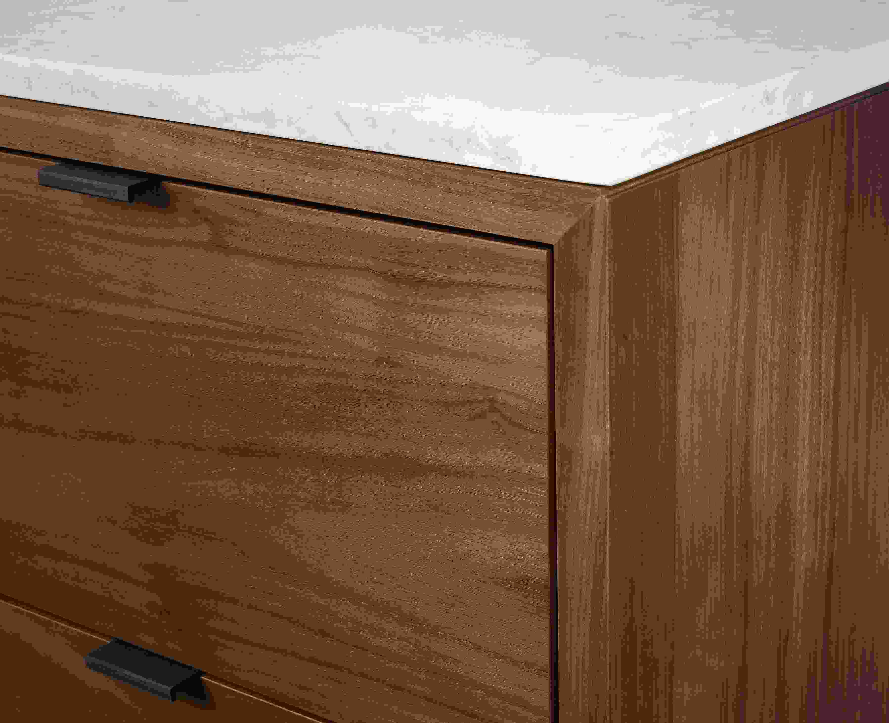 Close up detail of Copenhagen dining cabinet in walnut with marbled white quartz top.