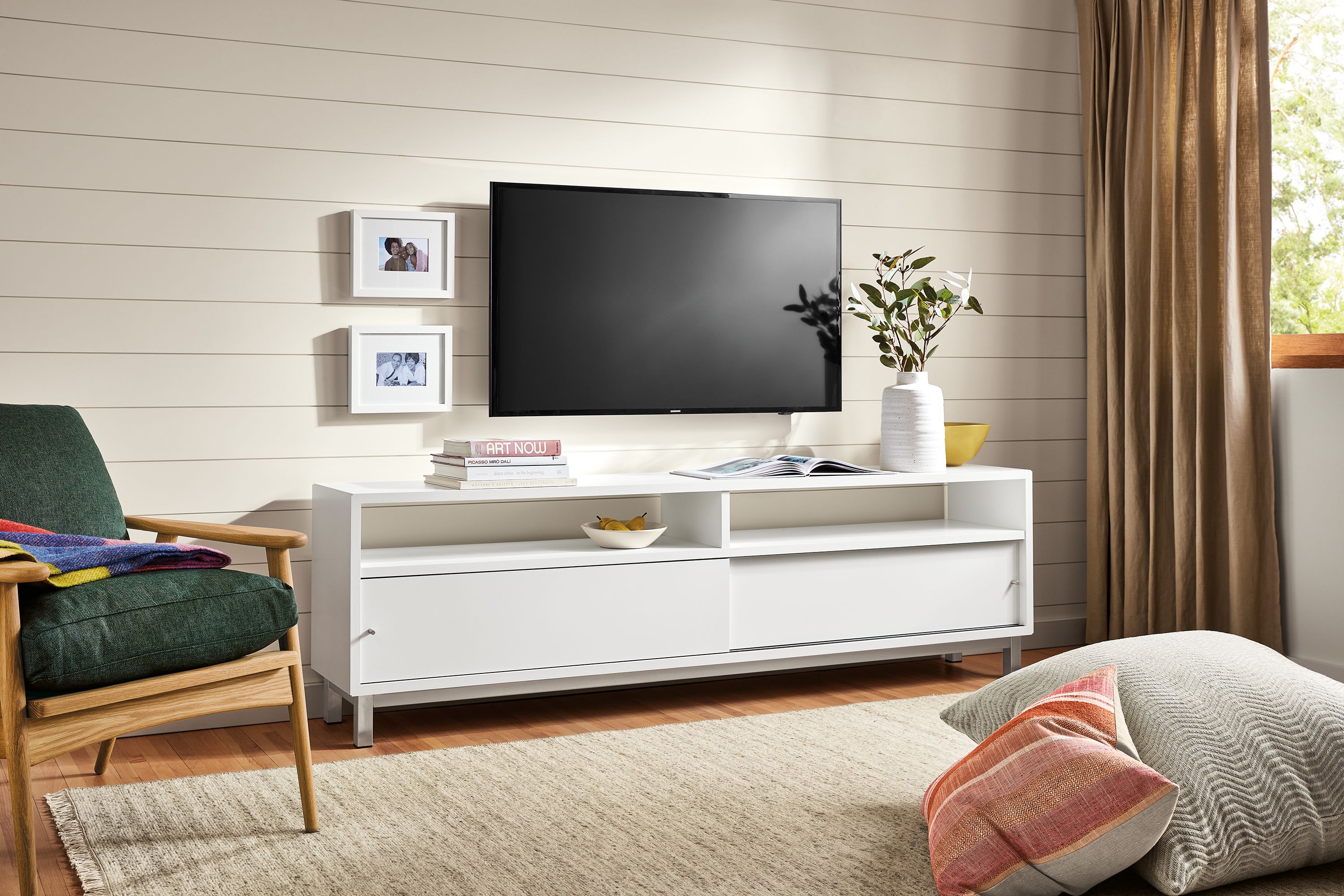 living room with copenhagen media cabinet, ericson lounge chair, floor pillows.