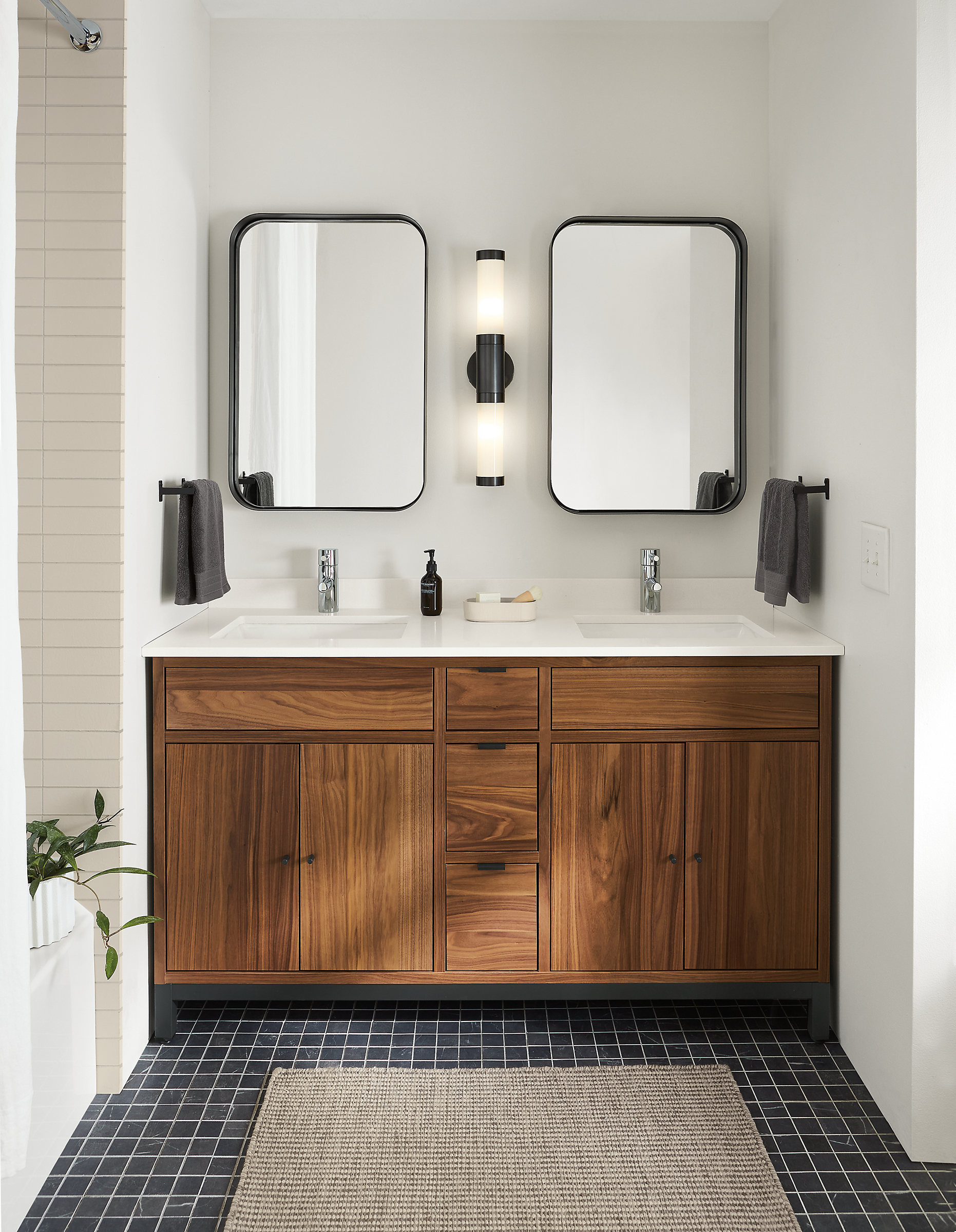 bathroom with Copenhagen 60-wide vanity in walnut with white quartz top and black steel base.