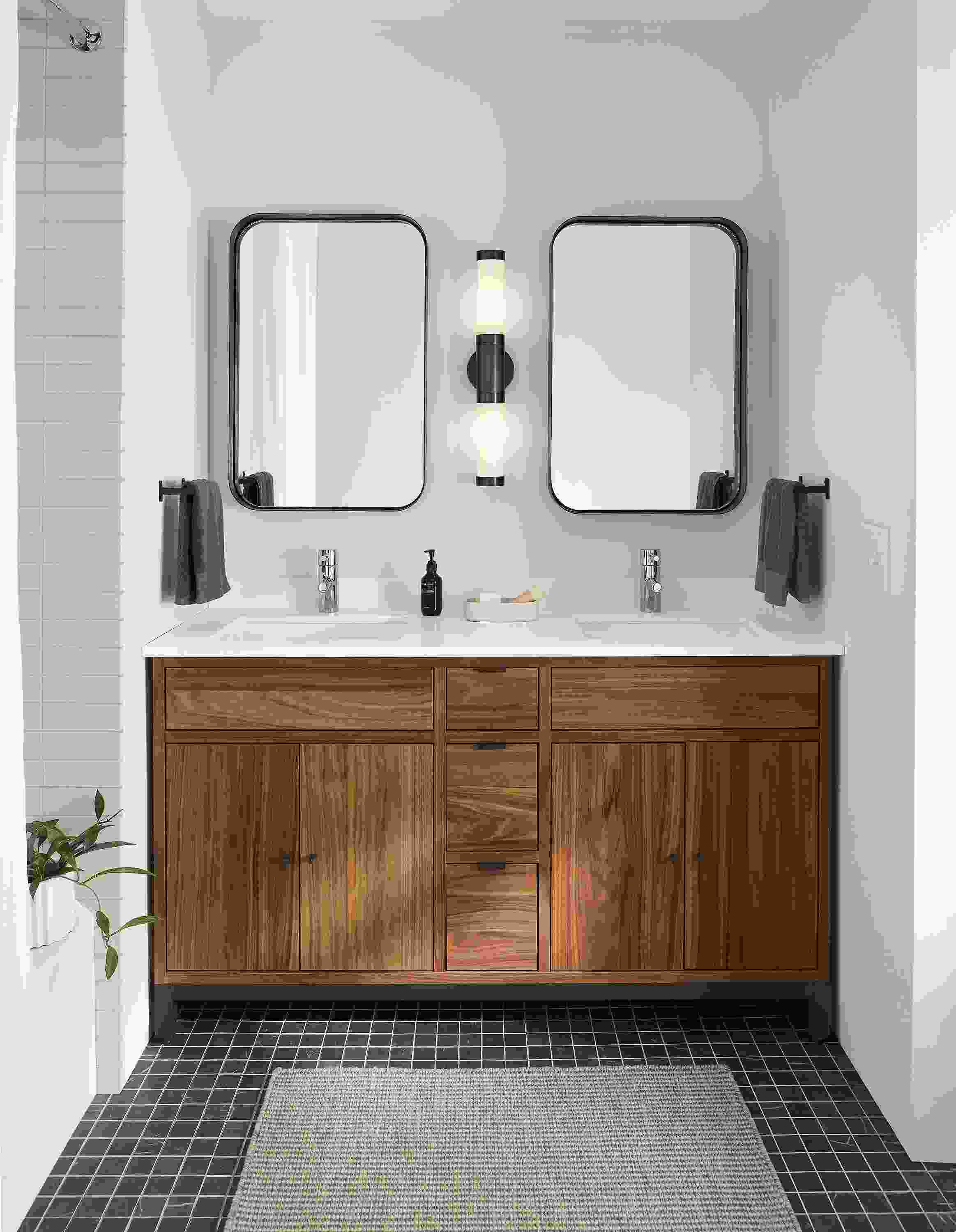 Bathroom with Copenhagen 60-wide vanity in walnut with white quartz top and black steel base.