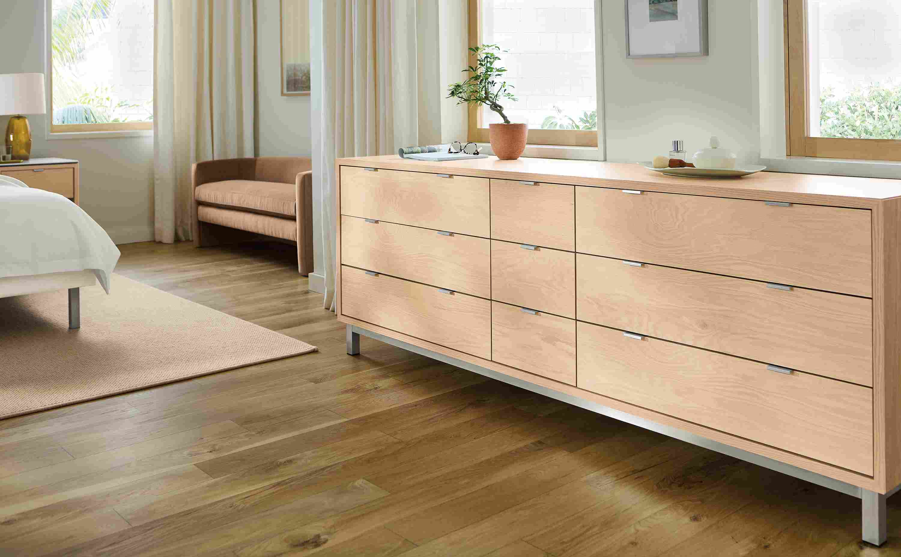 Bedroom with detail of copenhagen 84-wide, 9-drawer dresser in salt on red oak and flannery rug in oatmeal.