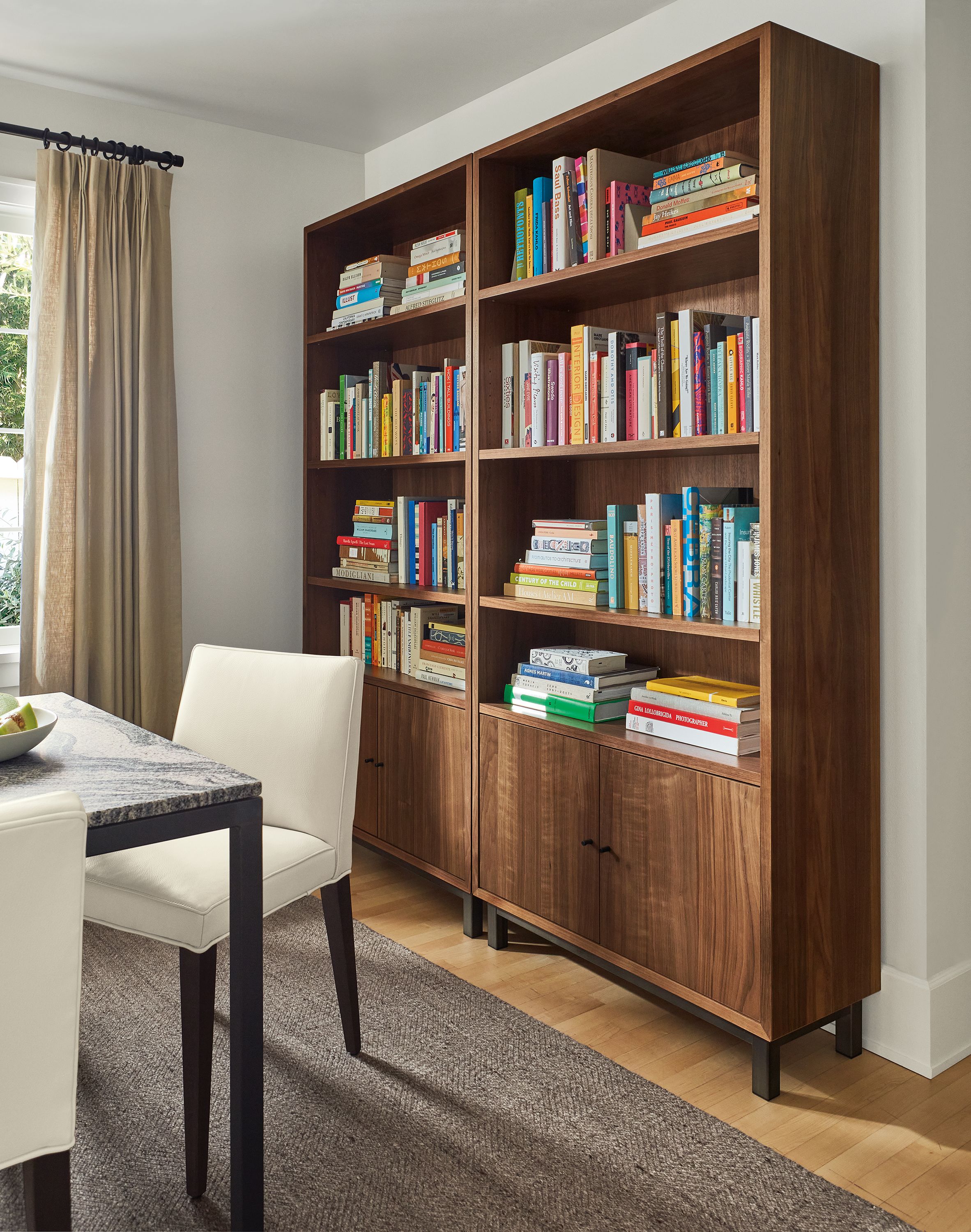 Living room with two Copenhagen 36-wide bookcases in walnut and avilia rug in foxhound.