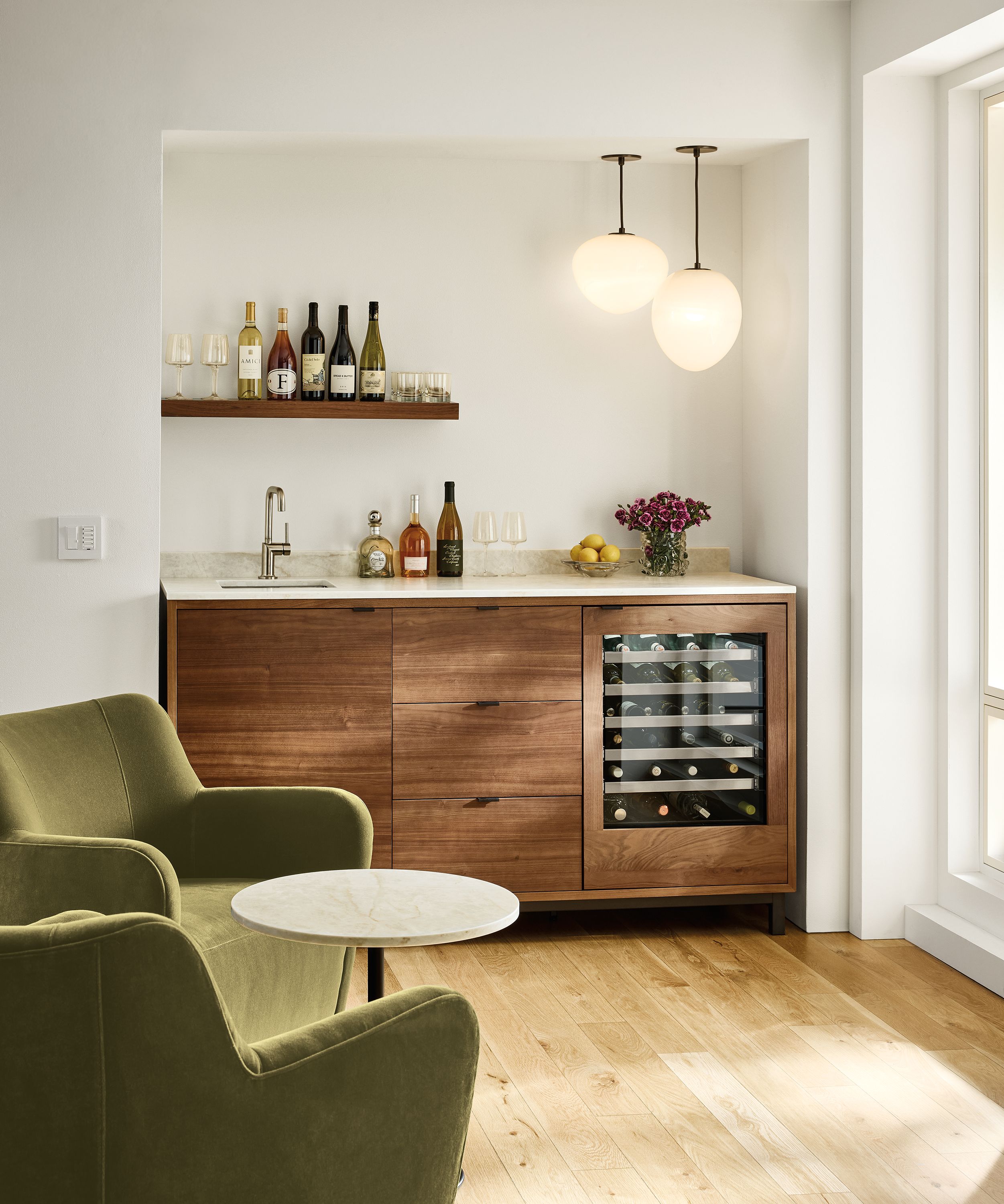 Home bar area with Copenhagen wet bar fridge cabinet with sink top and glass door wine fridge in walnut.