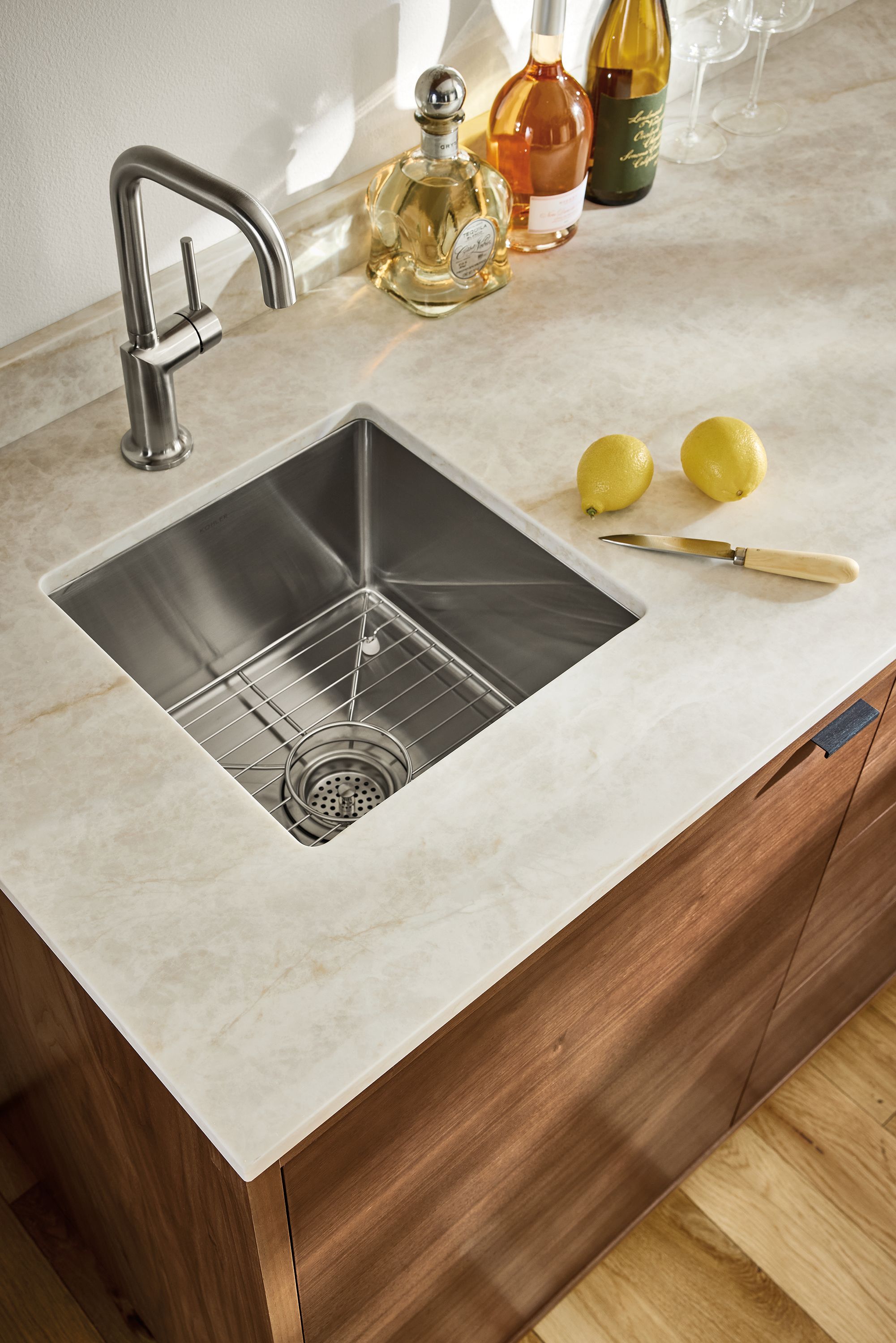 Hi-angle view of mahal quartz sink top on a copenhagen wet bar fridge cabinet in walnut.