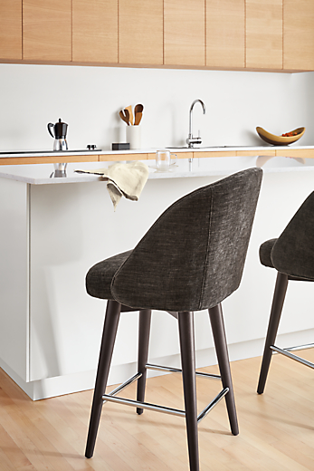 Cora swivel counter stool in mori charcoal fabric set at kitchen counter.