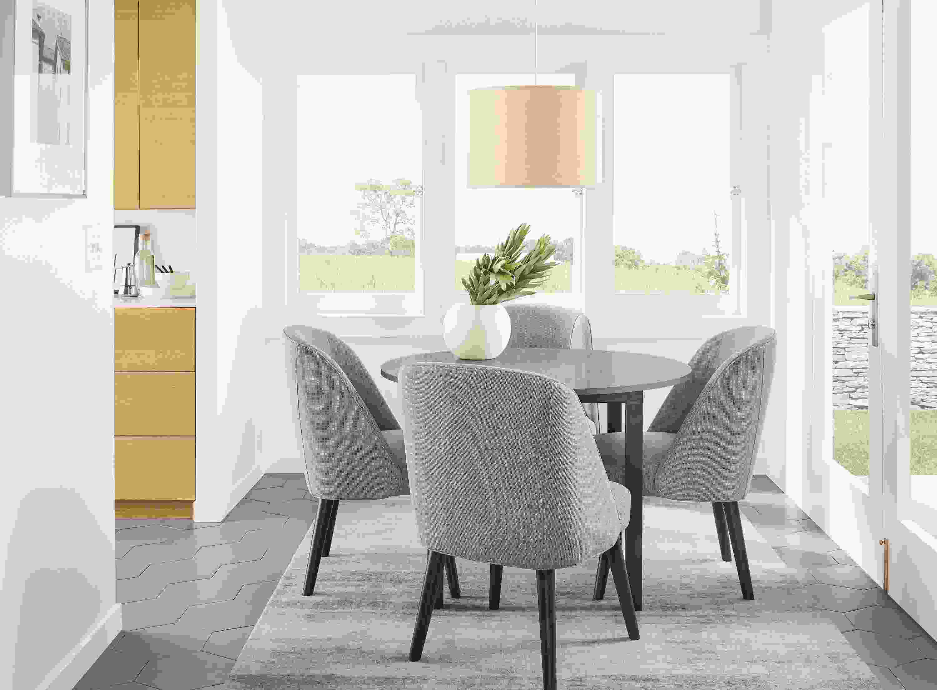 Detail of Cora side chairs in Sumner Steel fabric at round kitchen table.