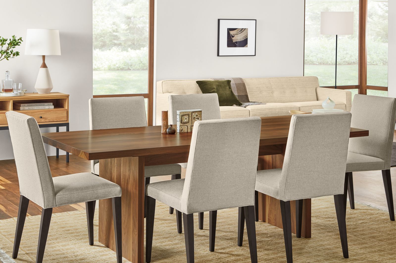 Detail of Corbett dining table in walnut in dining room with Ava side chairs.