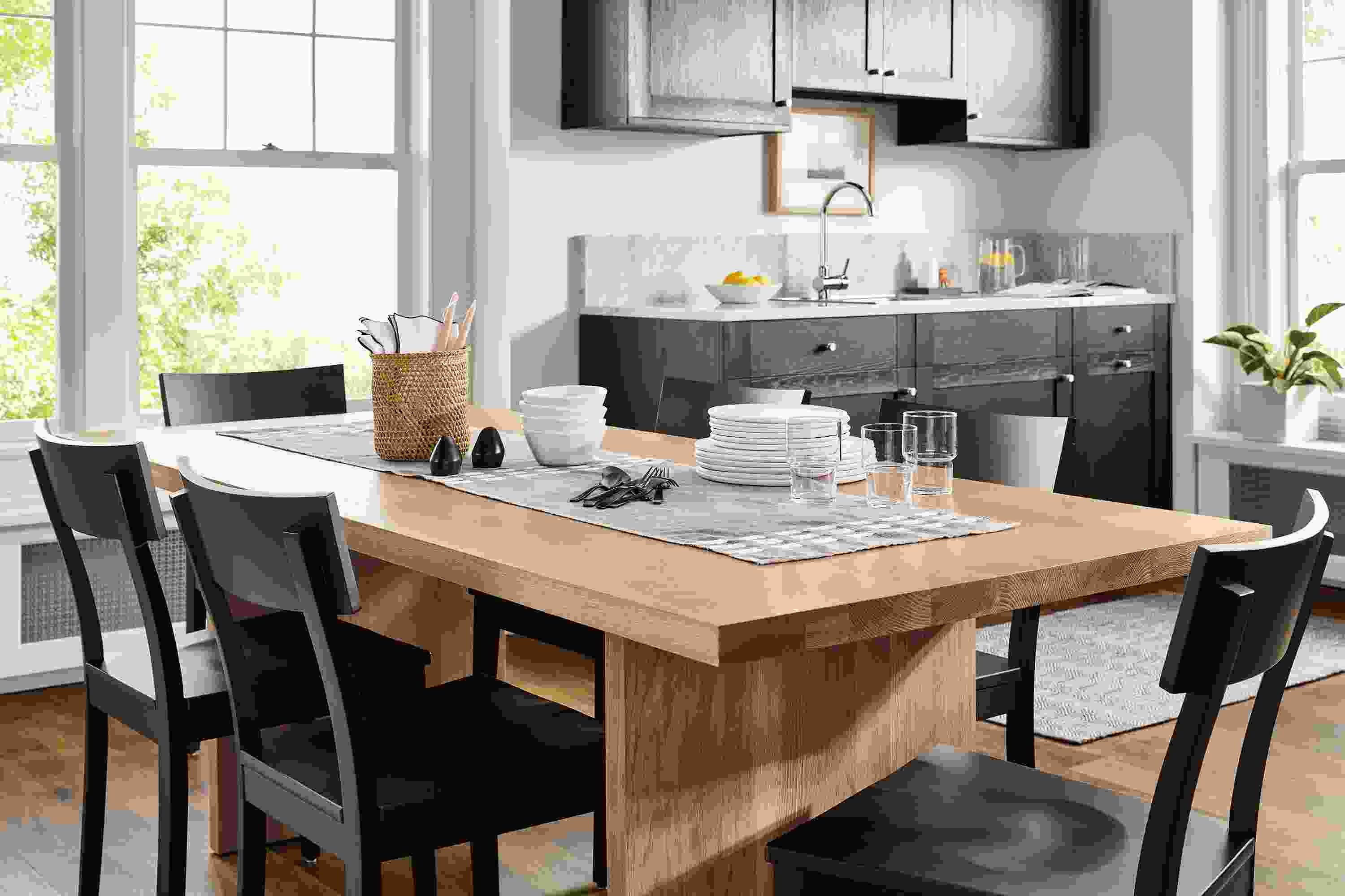 Dining area with corbett table in rye on red oak and 6 doyle side chairs in charcoal on maple.