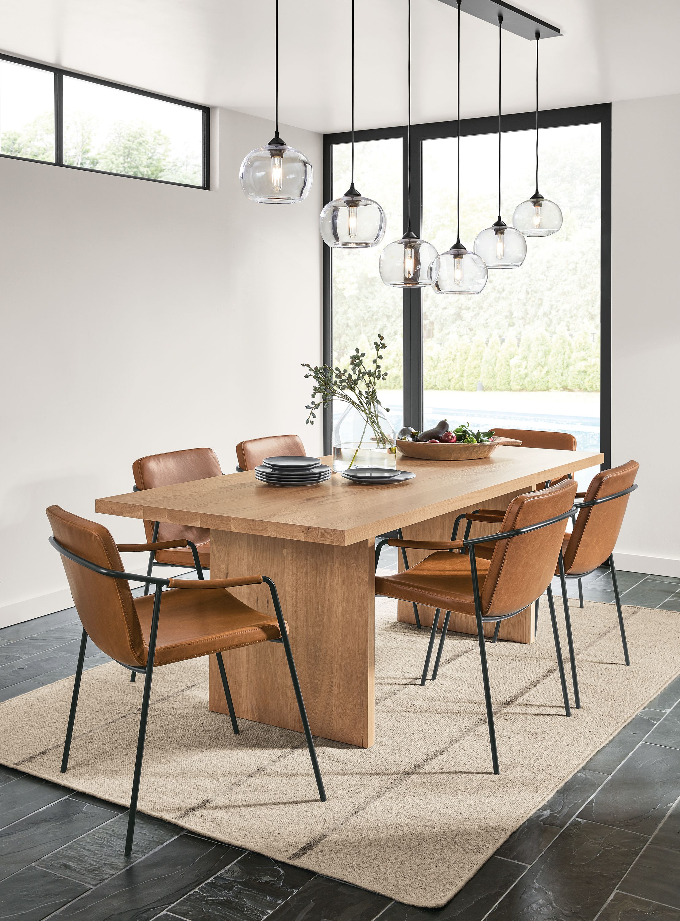 Dining room with corbett table in rye on red oak and 6 mazie chairs in brown synthetic leather.