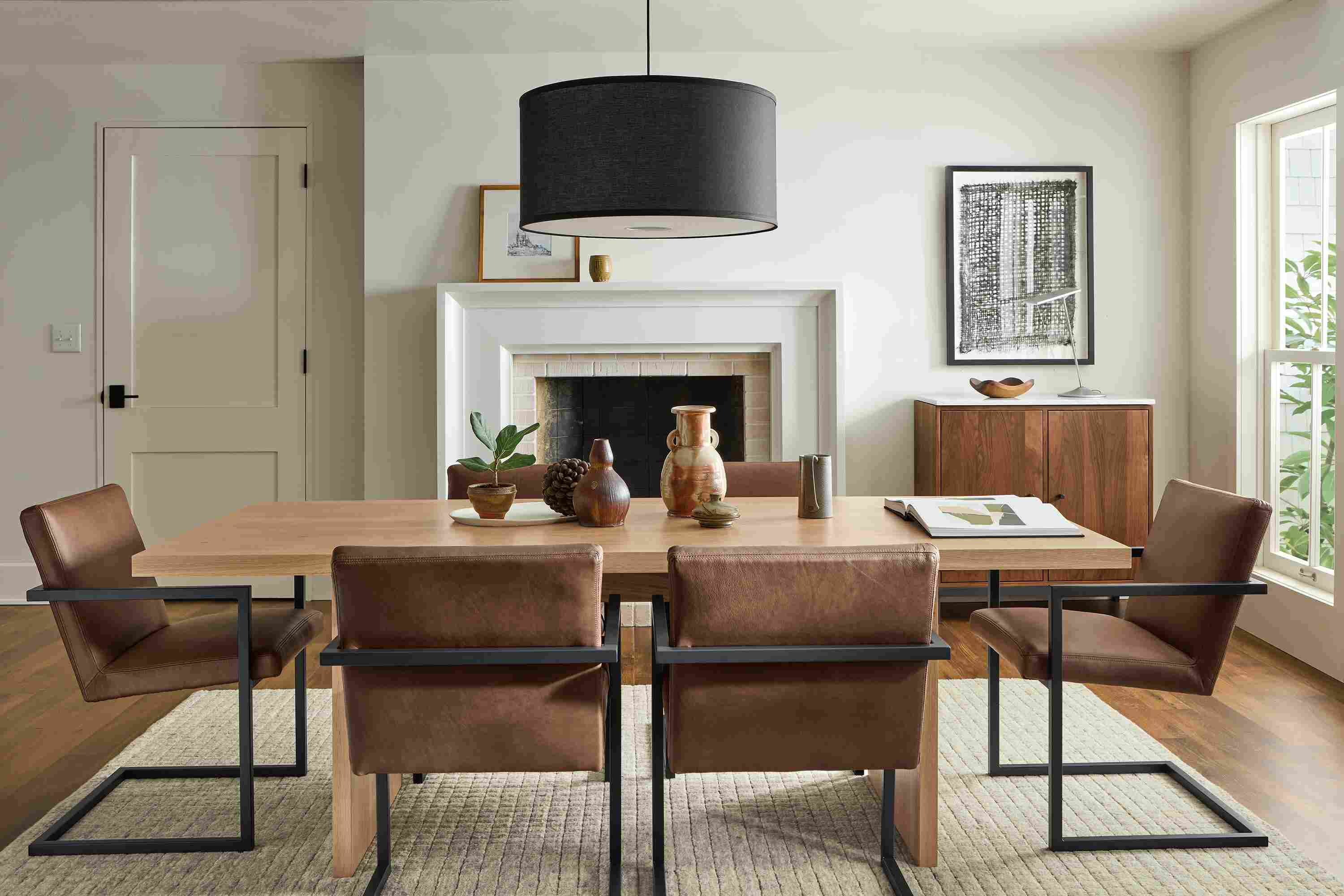 Dining room with Corbett table in rye on red oak and 6 Lira arm chairs in Laino Cognac leather.